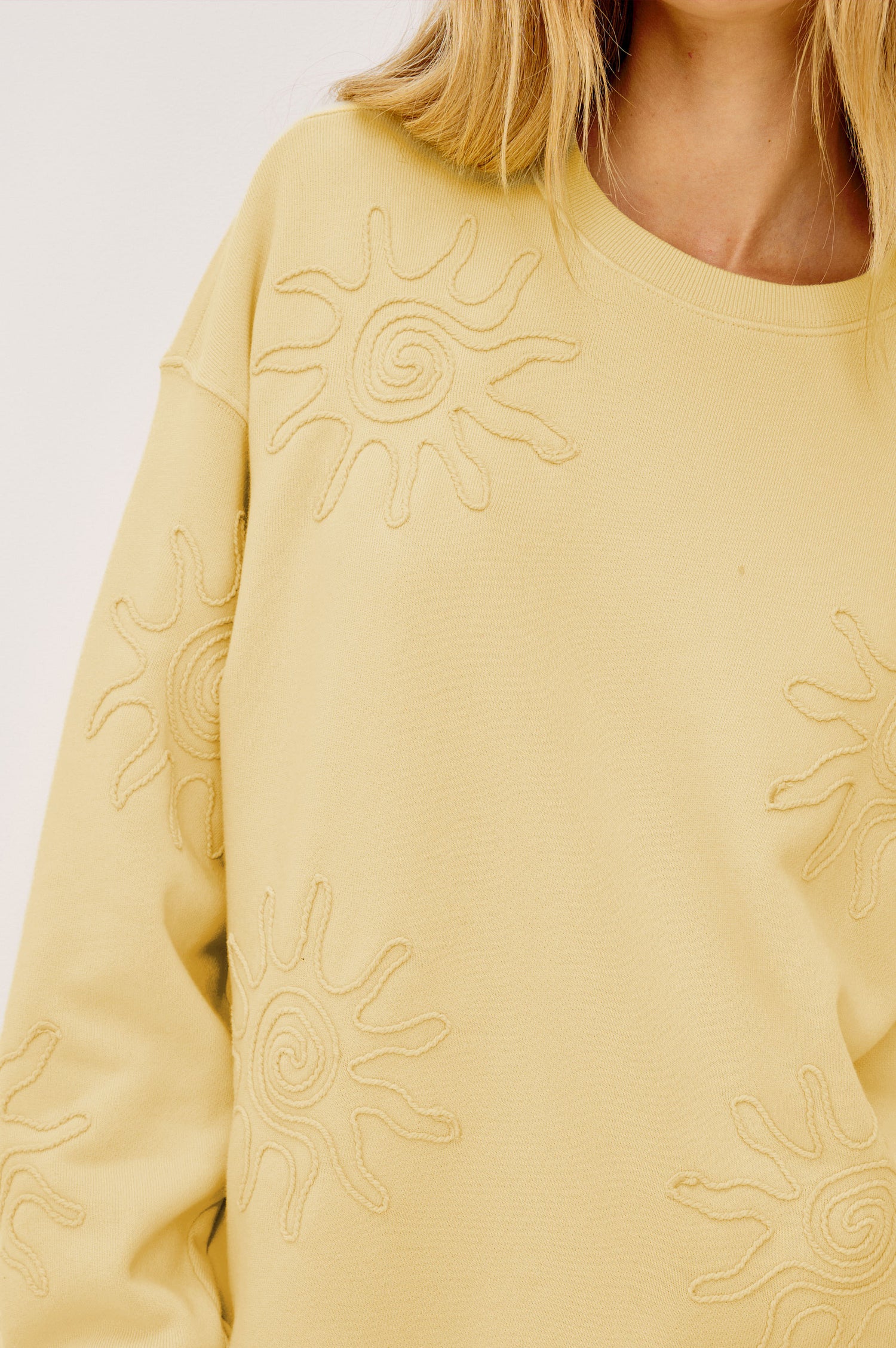 Beckley Sweatshirt in French Terry With Soutached Suns, Relaxed Fit, and Long Sleeves in Sunshine Colorway - Upper Body Front View Featured on Model