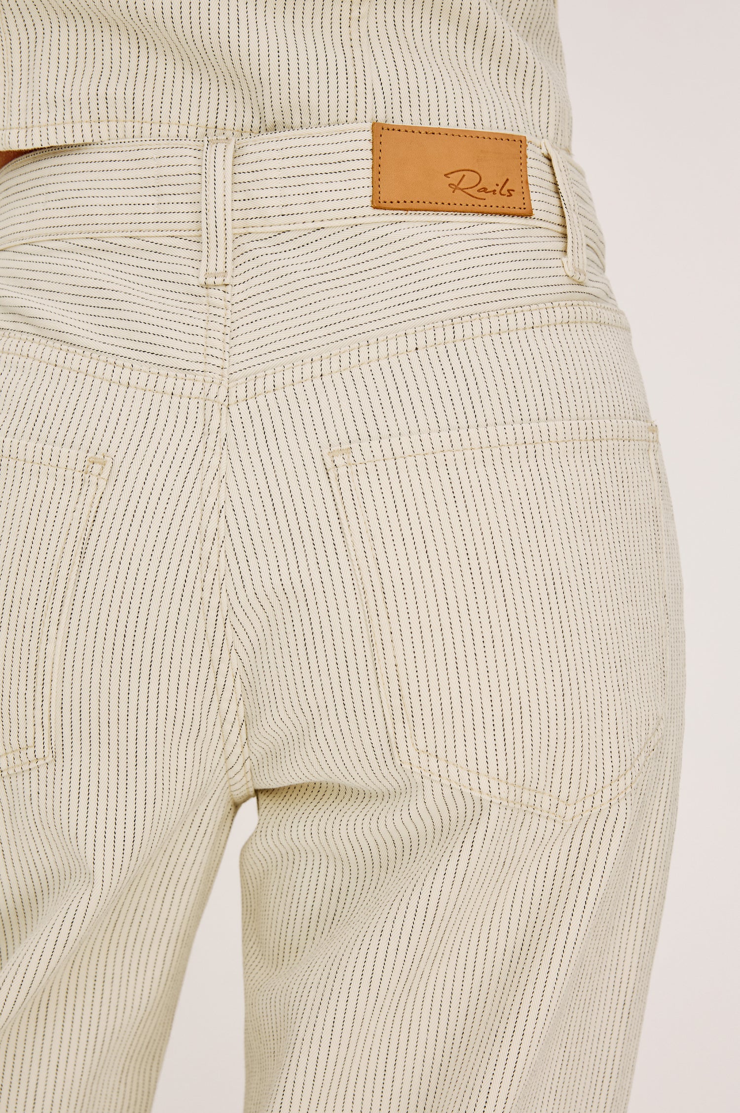 Belmont Arc Leg Jean in Rigid Denim With High-Waisted Fit, Button Fly, and 32″ Inseam in Ecru Railroad Stripe Colorway - Lower Body Back View Featured on Model