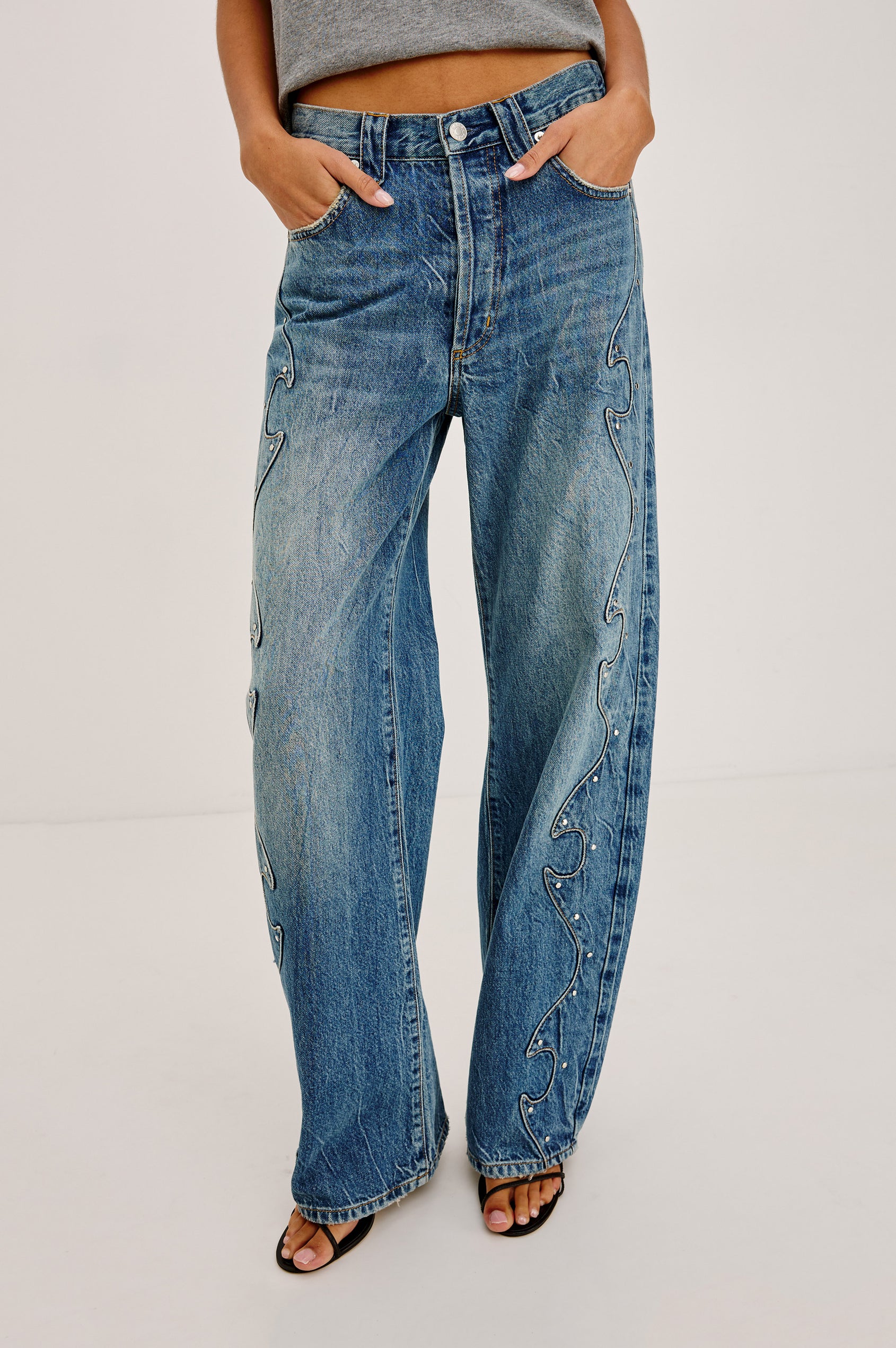 Belmont Arc Leg Jean in Rigid Denim With High Rise, Western Side Seam and Stud Detailing, Button Fly, and Side and Back Pockets in Night Cap Colorway - Lower Body Front View Featured on Model