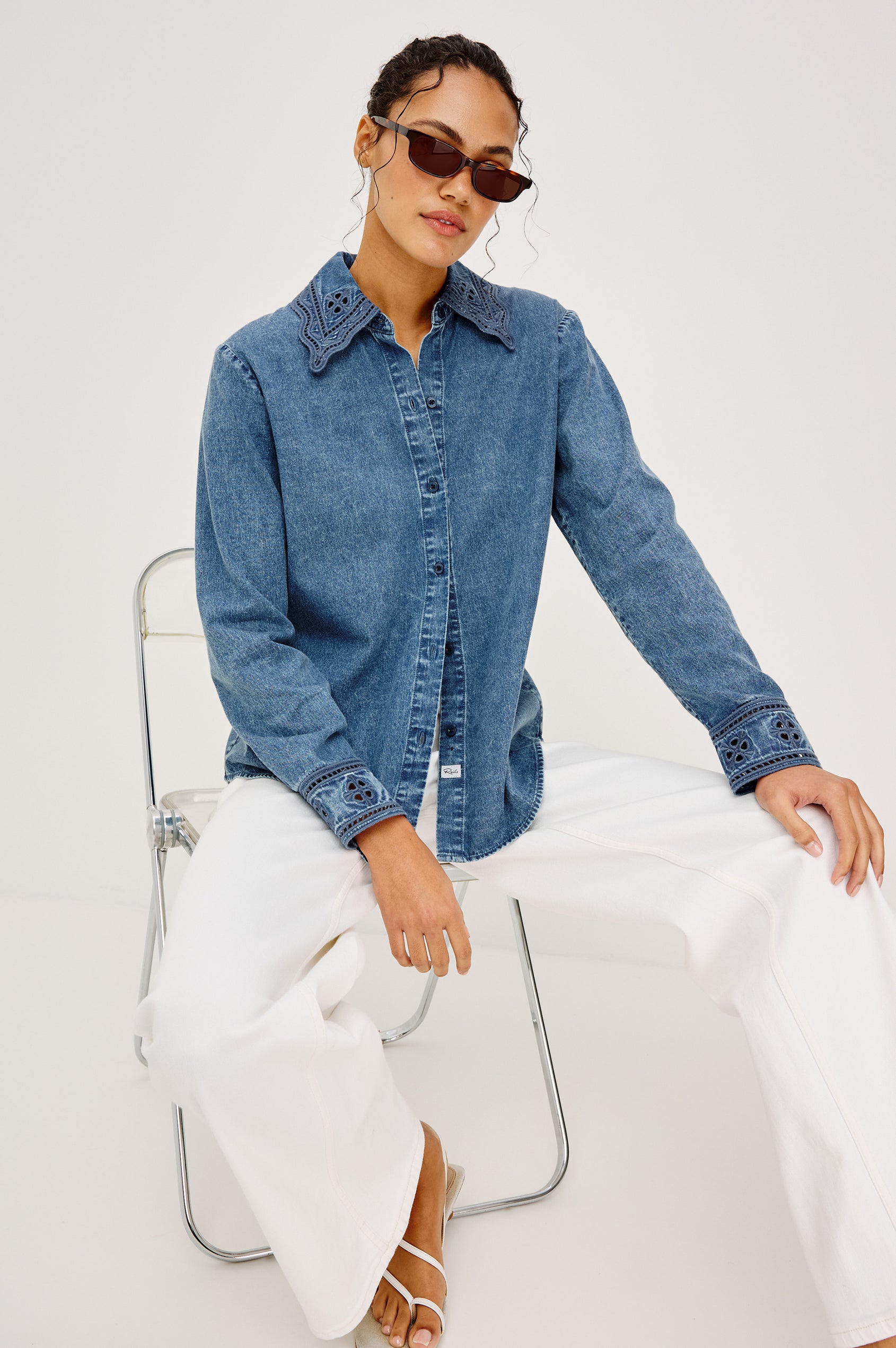 Bethany Button-Up Shirt in TENCEL™ Denim With an Embroidered Collar Long Sleeves and Loose Fit in Antique Blue Colorway - Full Body View Featured on Model Sitting