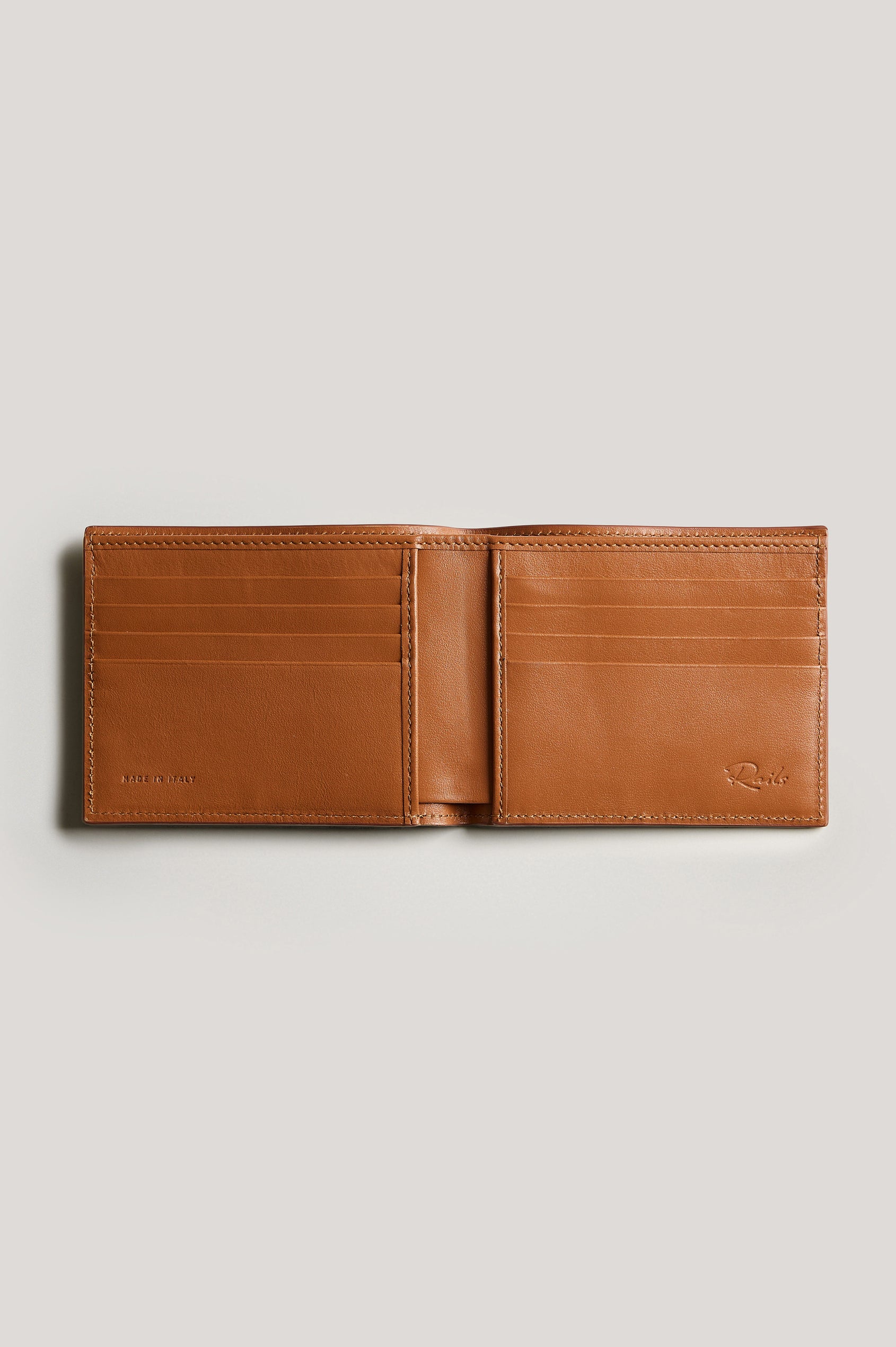 Leather wallet in cognac color, open. Inside view featured.