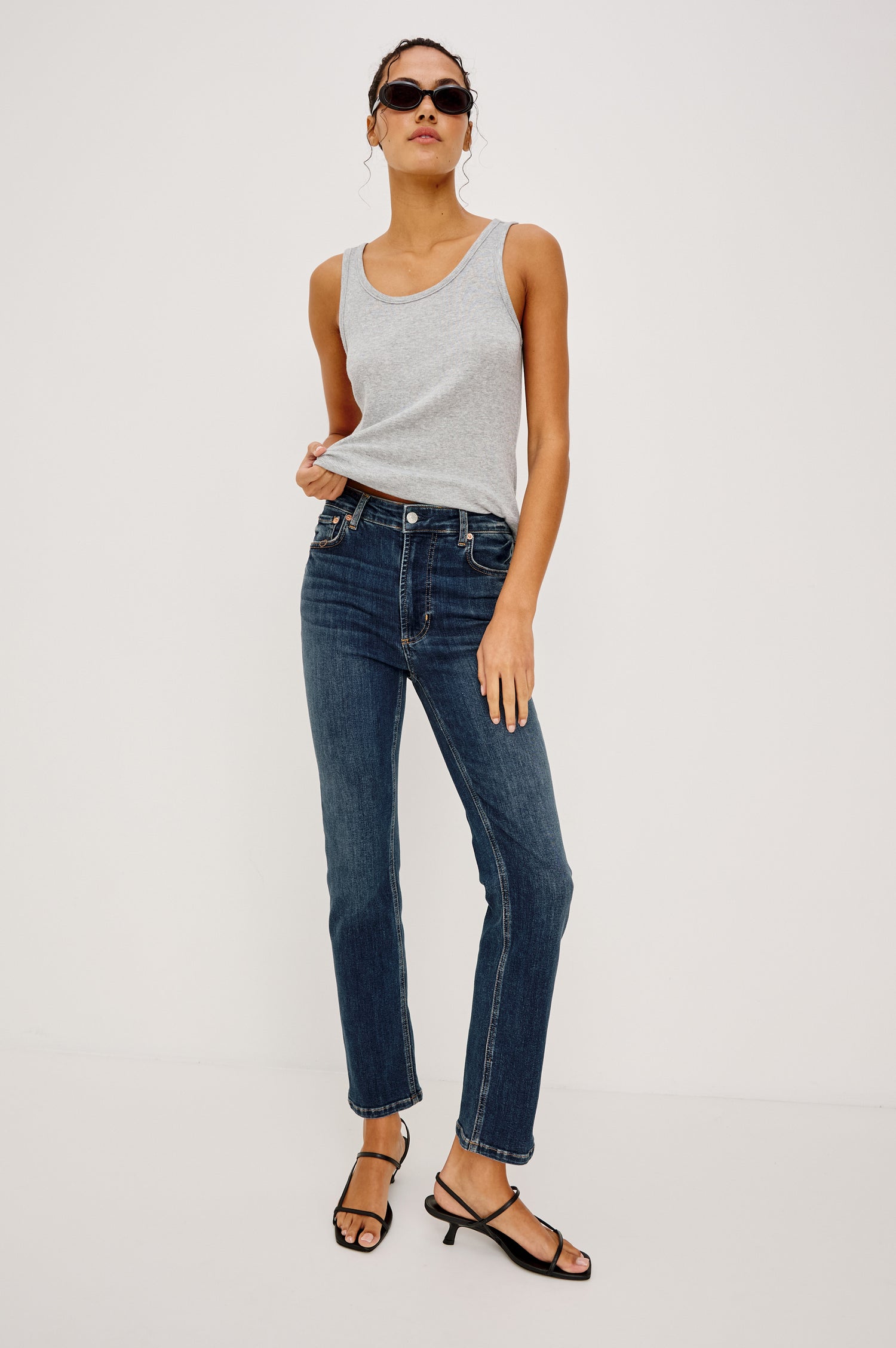 Bixby Mid-Rise Slim Straight Jean in High Stretch Denim With 25″ Inseam, Zip Fly, and 5-Pockets in Deep Dive Colorway - Full Body Front View Featured on Model Sitting