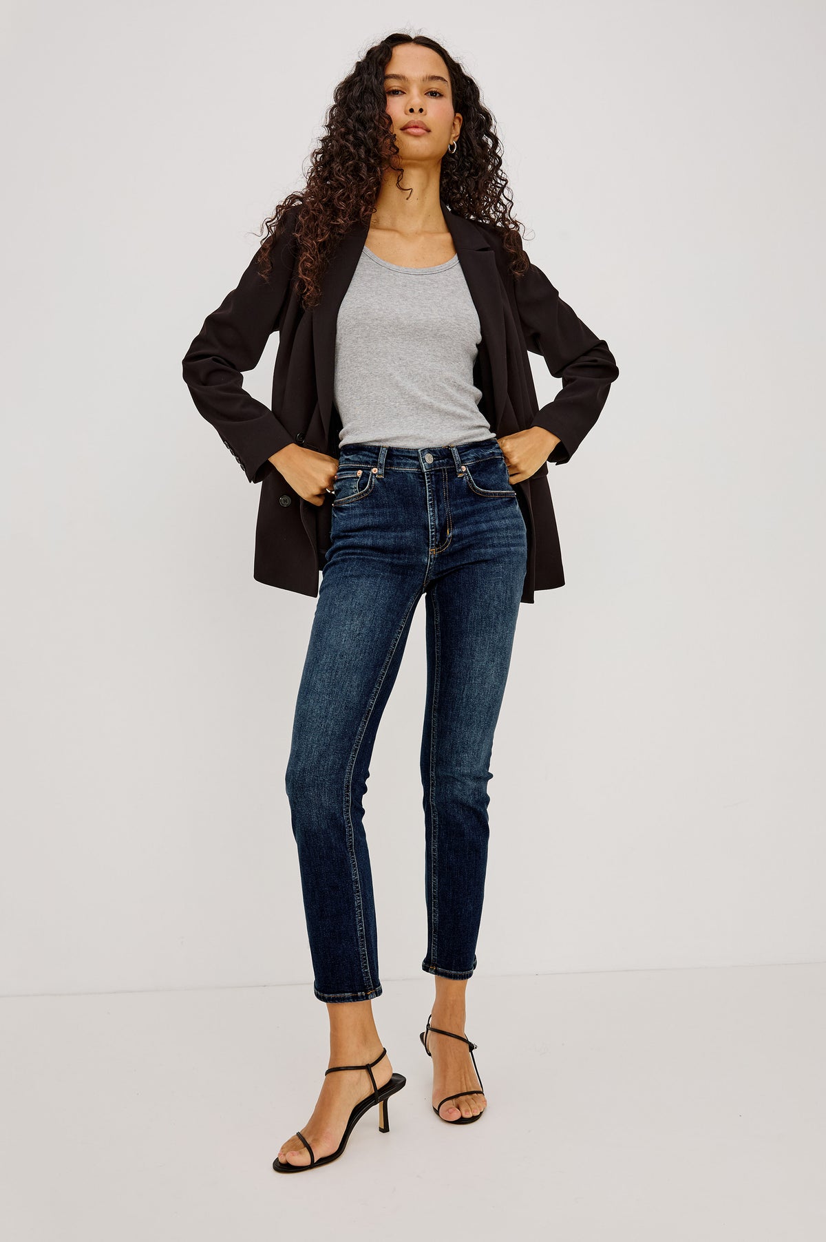 Bixby Mid-Rise Slim Straight Jean in High Stretch Denim With 25" Inseam, Zip Fly, and 5-Pockets in Deep Dive Colorway - Lower Body Front View Featured on Model