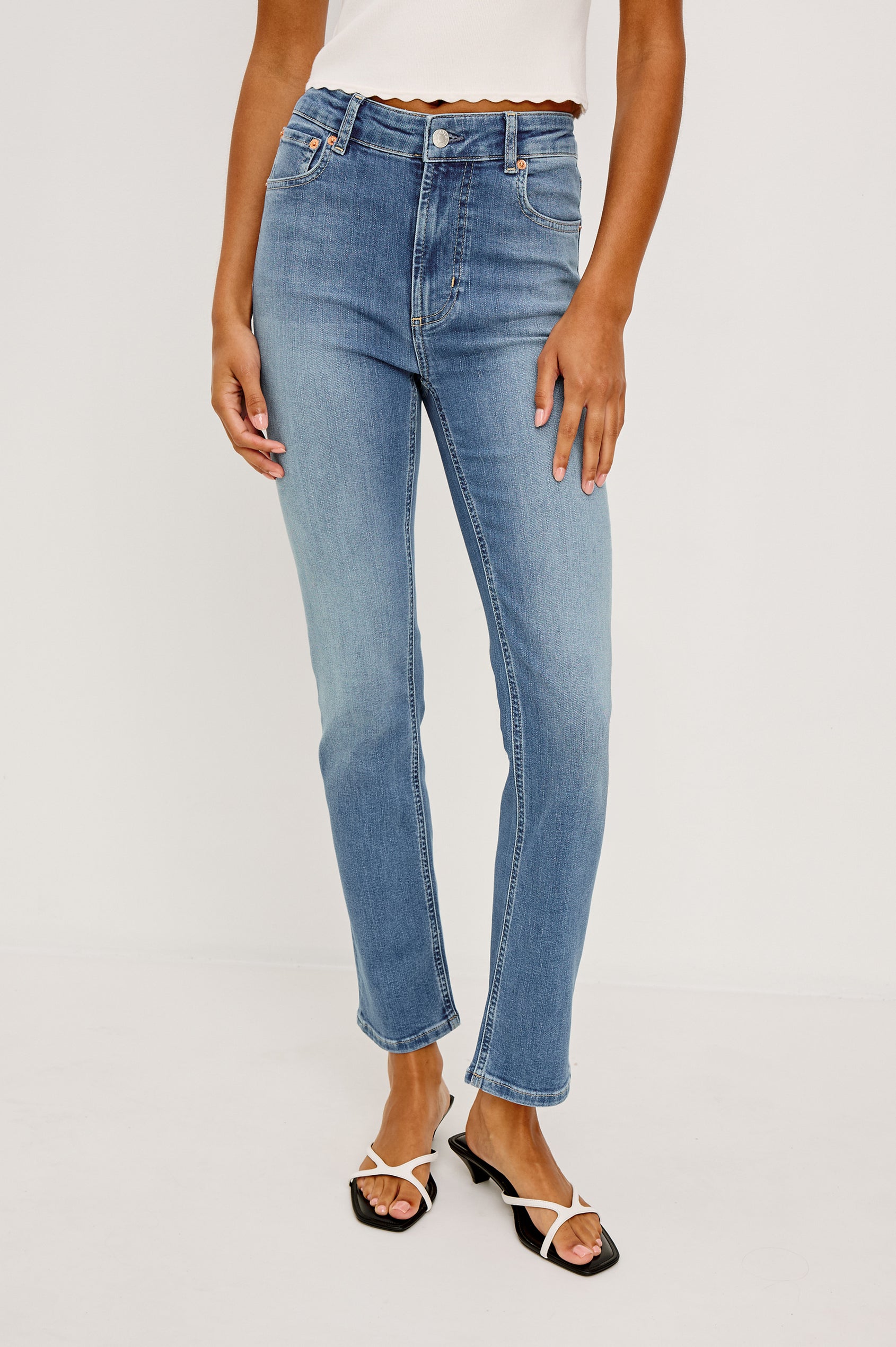 Bixby is a 5-pkt slim straight jean in Vista Blue colorway. Front view featured on model.