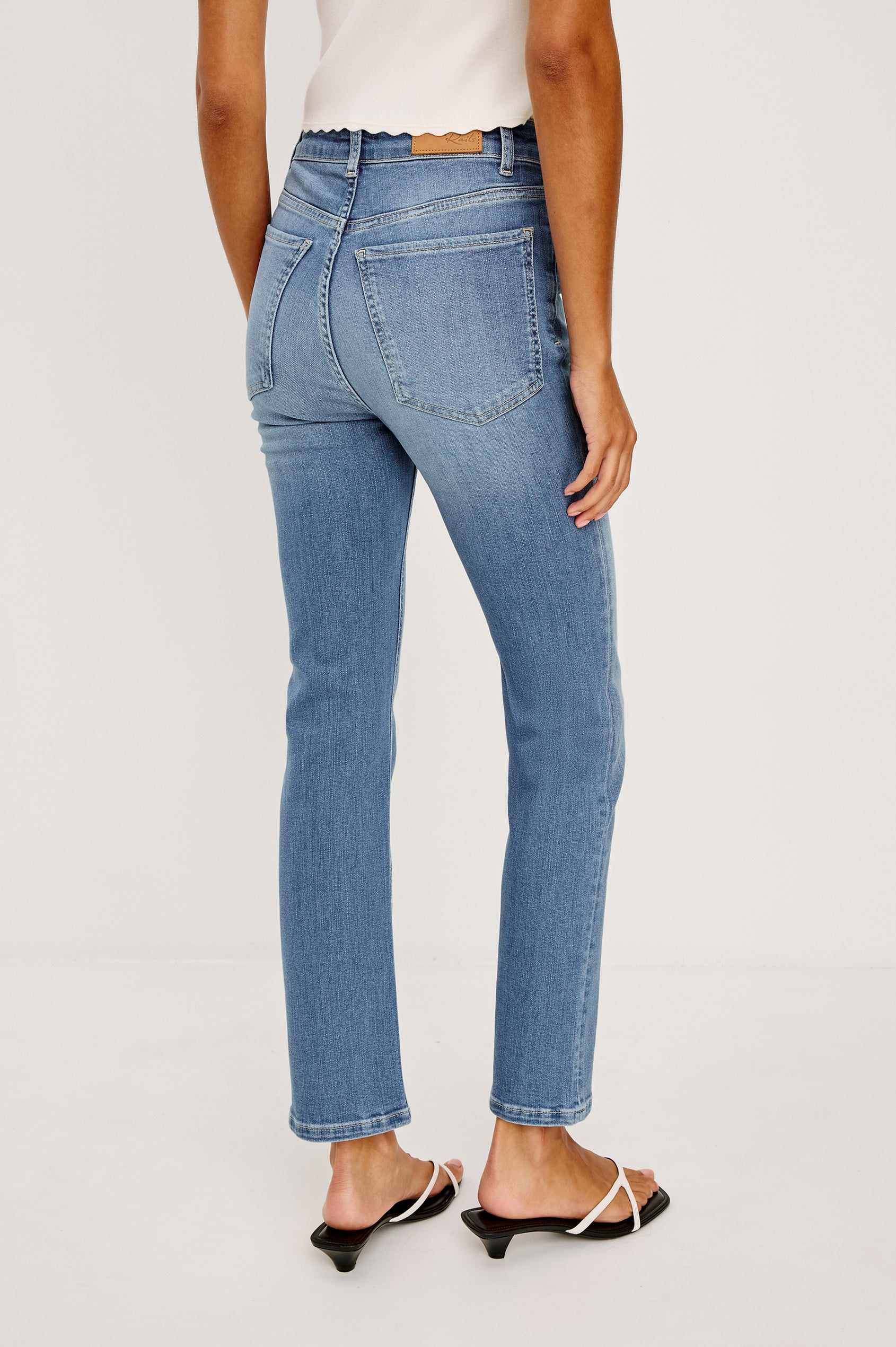 Bixby is a 5-pkt slim straight jean in Vista Blue colorway. Full body back view featured on model.