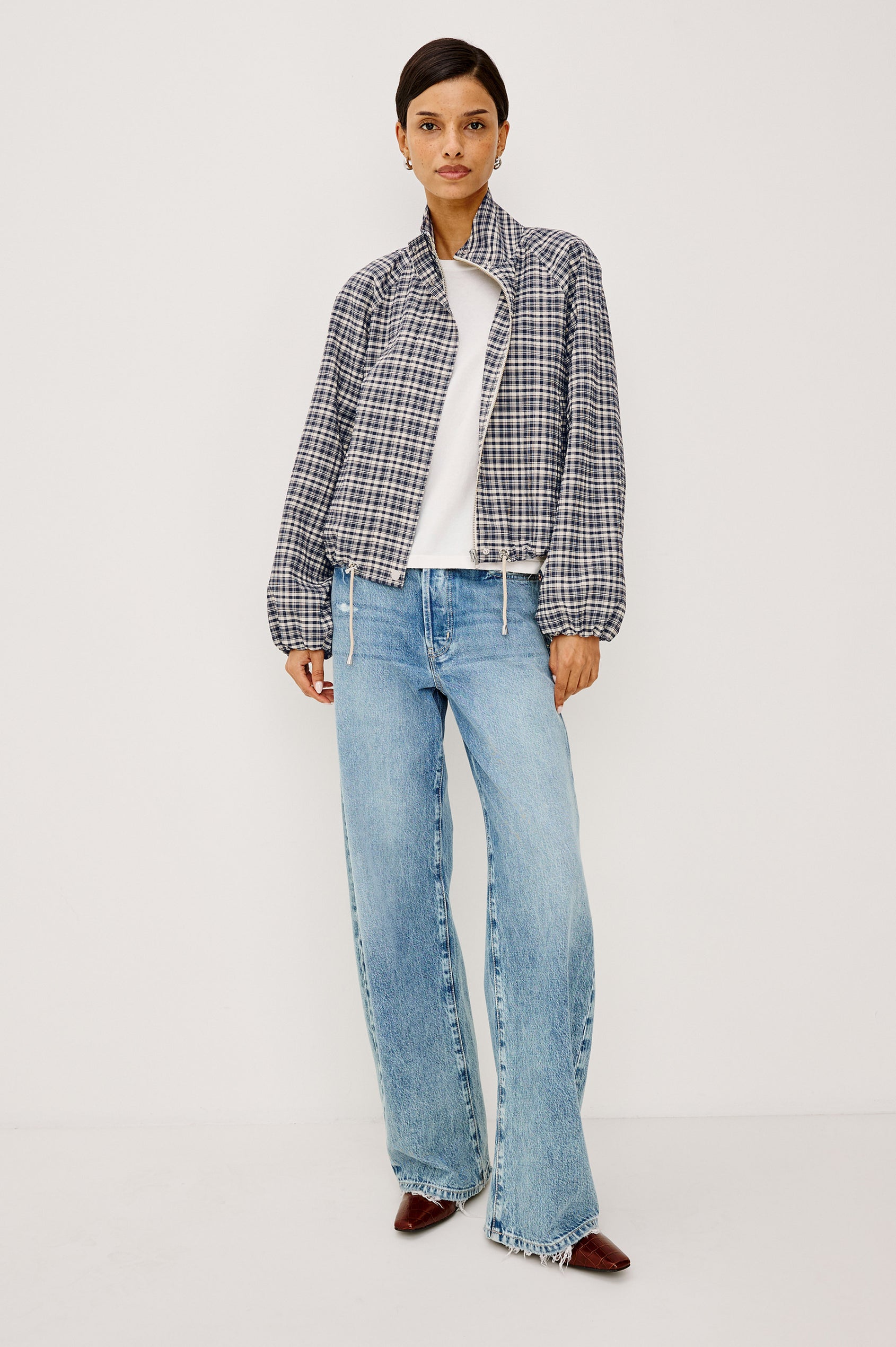 Blake Jacket in Crinkle Nylon Blend With Relaxed Fit, High Funnel Neck, Double Button Closures, Drop Shoulder Sleeves With Elastic Cuffs, and Cropped Drawstring Hem in Mini Check Colorway - Full Body Front View Featured on Model