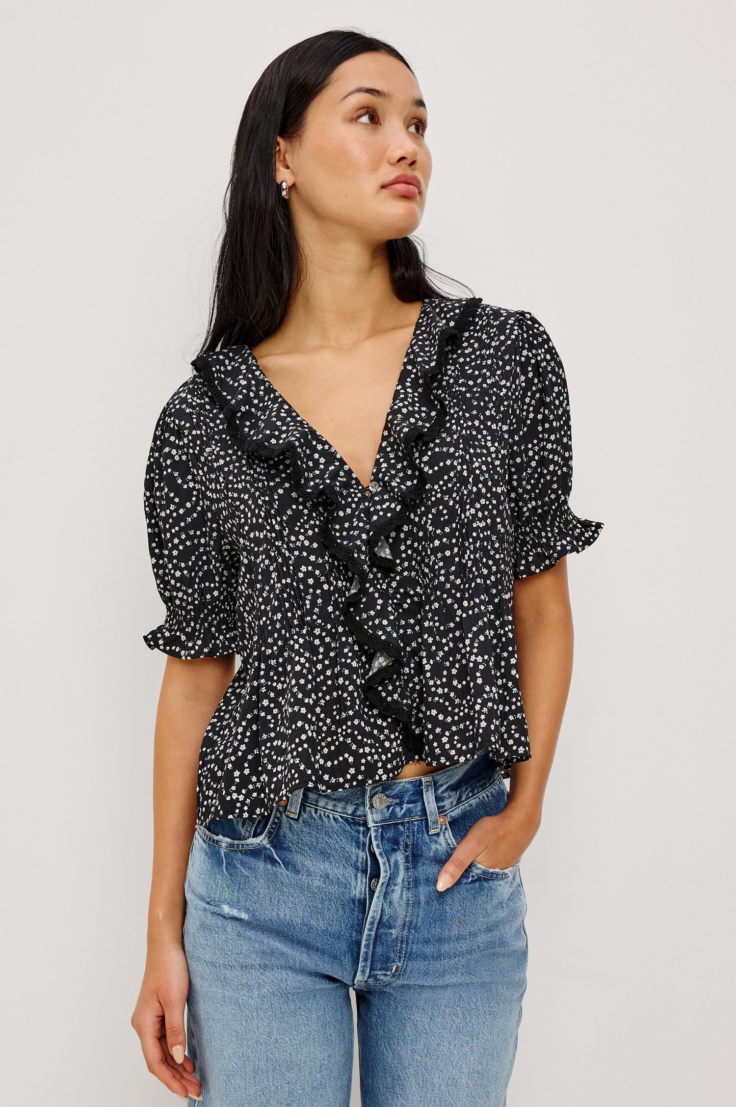 Bloom Poplin Top With Ruffle V-Neckline, Elbow-Length Puff Sleeves With Ruffled Cuffs, Pintuck Detailing, and Boxy Relaxed Fit in Mini Chain Daisies Colorway - Upper Body Front View Featured on Model