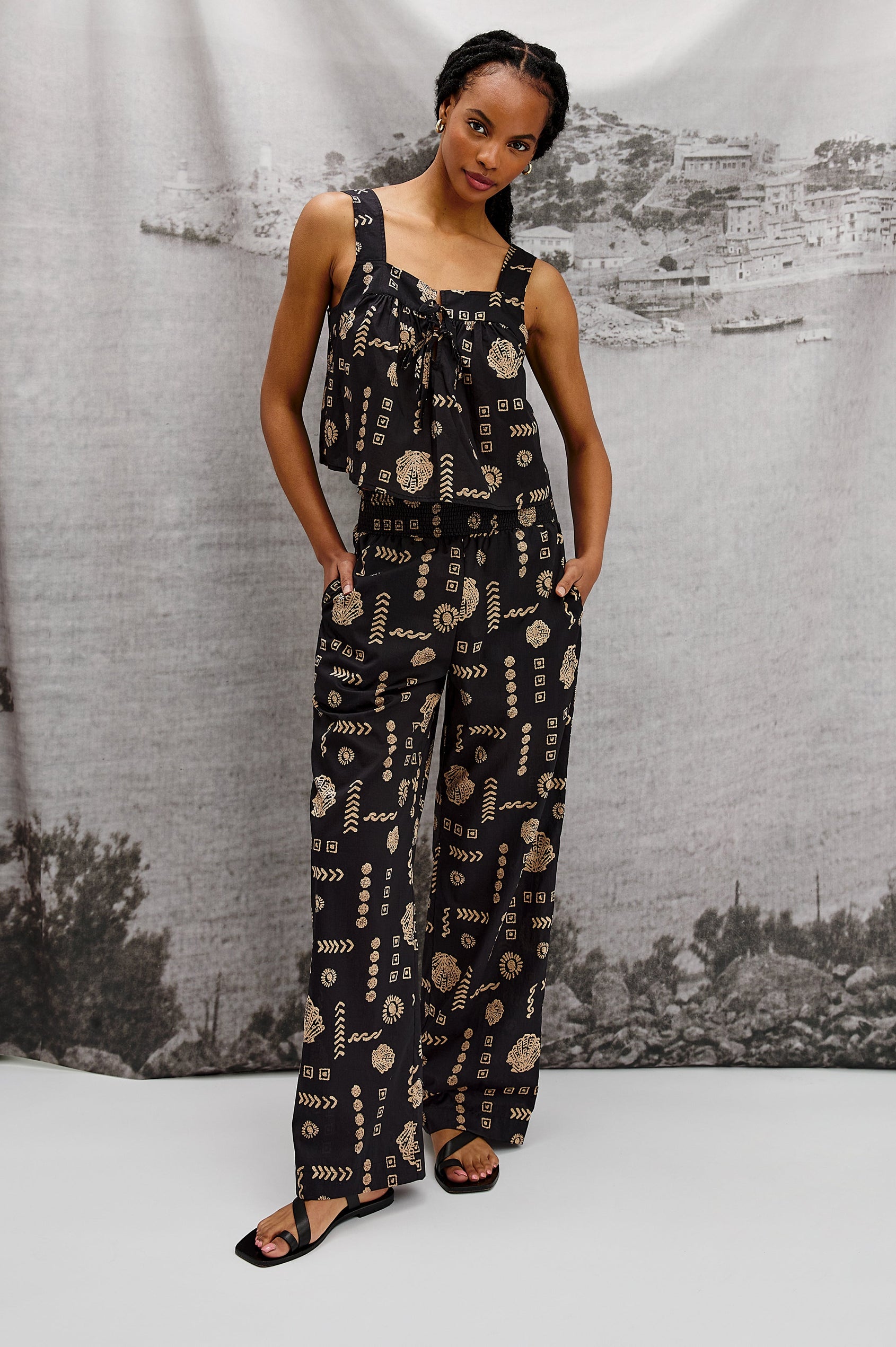 Blythe Square Neck Tank Top with Wide Straps and Two Front Ties in Beach Shells Colorway. Stylized full body front view on Model.