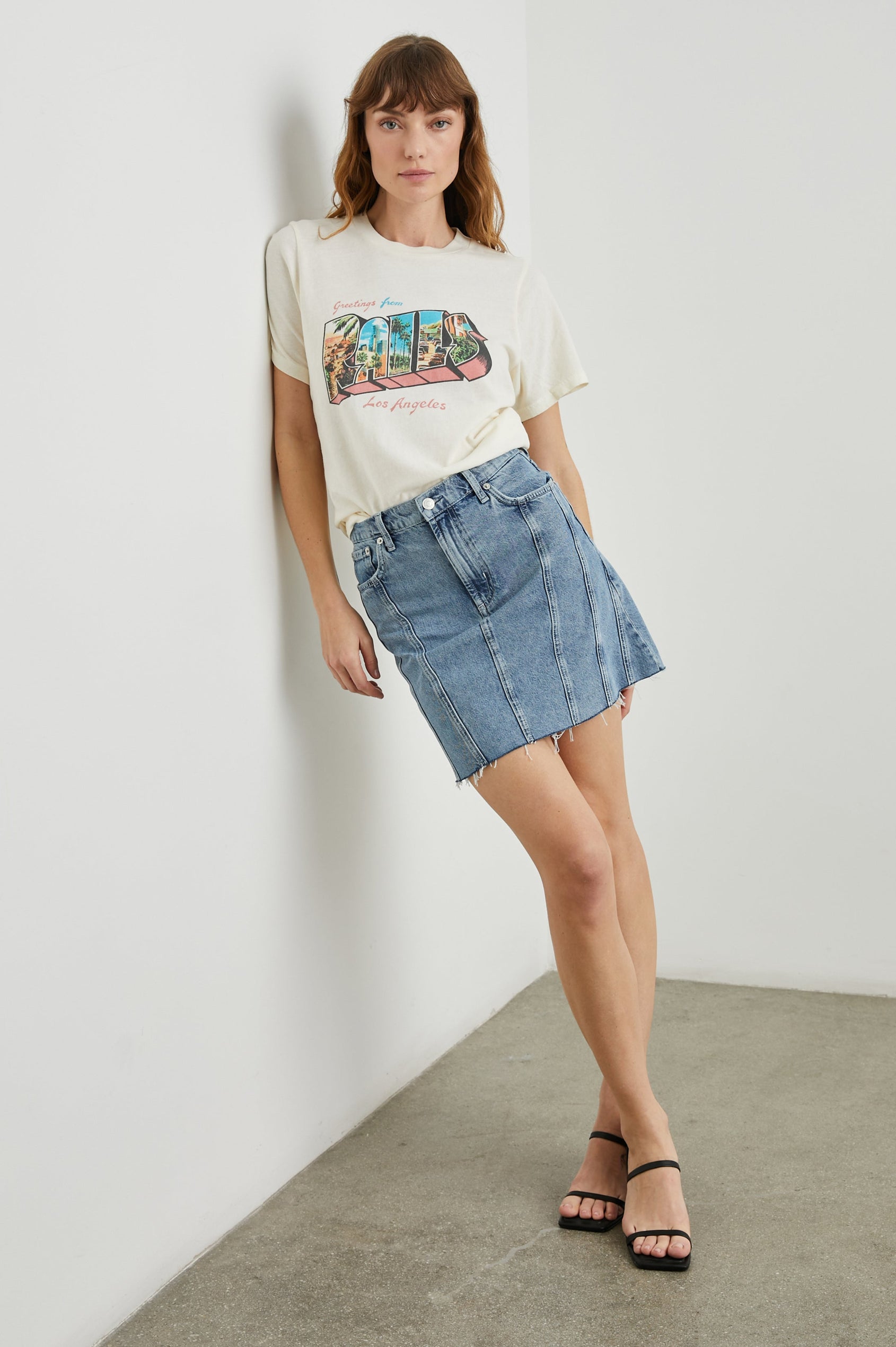 Boyfriend T-Shirt with a Crew Neck, photographs of Los Angeles and the text, Greetings From Rails Los Angeles in Rails Los Angeles Ecru Colorway, with text in Pink and Blue - Front Tucked Full Body View Featured on Model