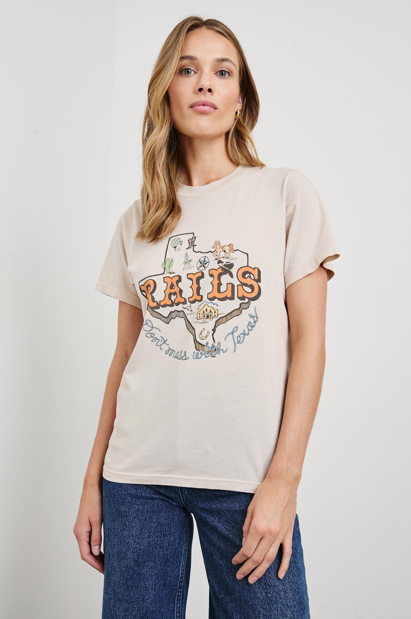 Boyfriend T-Shirt with a Crew Neck, Texas images, and the text, Texas, Don't Mess with Texas in Rails Texas Colorway, with text in orange and blue on Tan - Front View Featured on Model