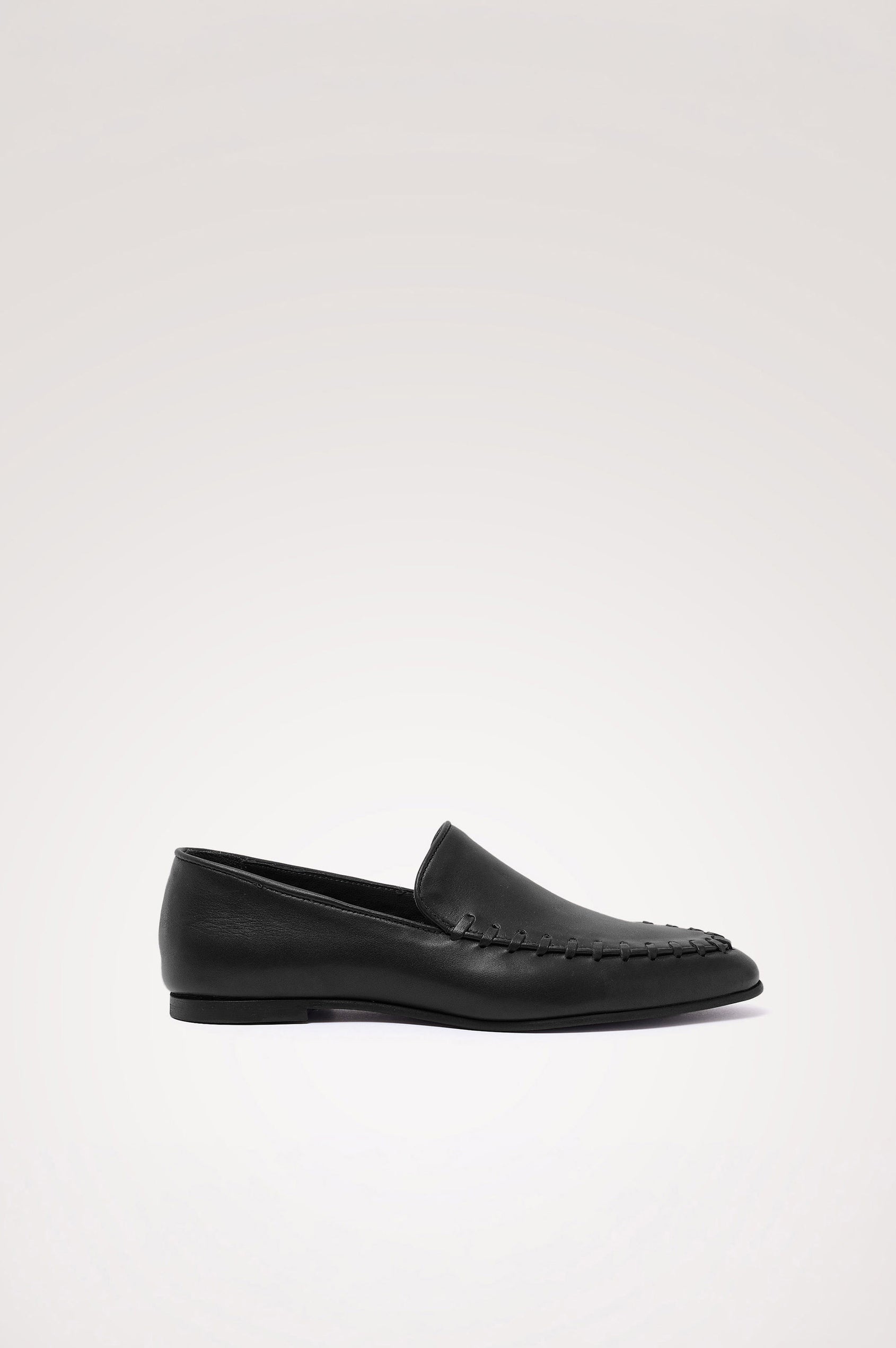 Braga Loafer in Full-Grain Leather With Whipstitch Trim, Narrow Vamp, and Low Heel in Black Colorway - Side Product View Featured