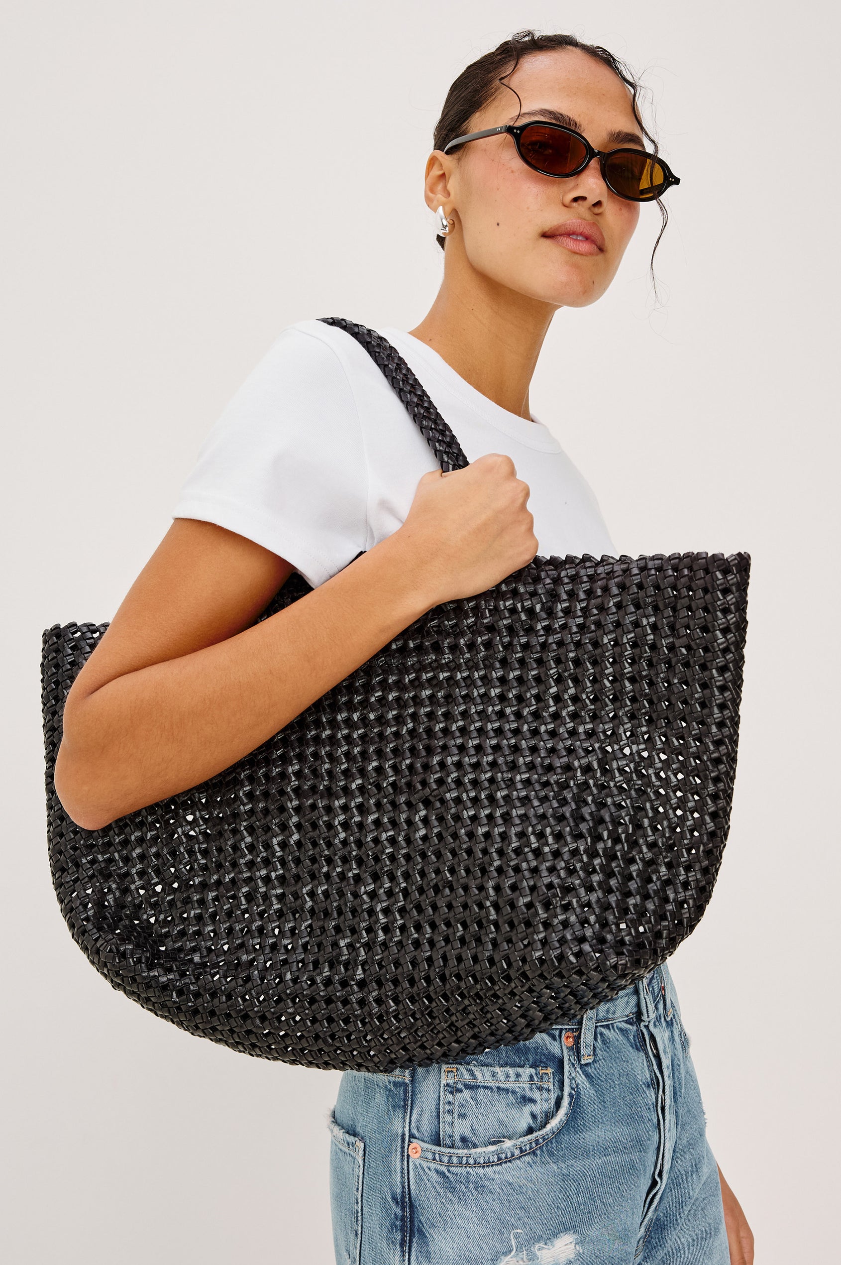 Brava Tote in Woven Leather With Top Handles and Spacious Interior in Black Colorway - Upper Body View Featured on Model