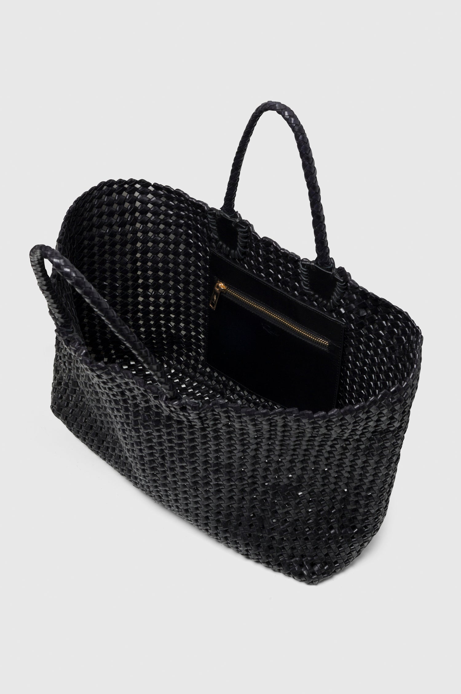 Brava Tote in Woven Leather With Top Handles and Spacious Interior in Black Colorway - angeled view, off model, opened.