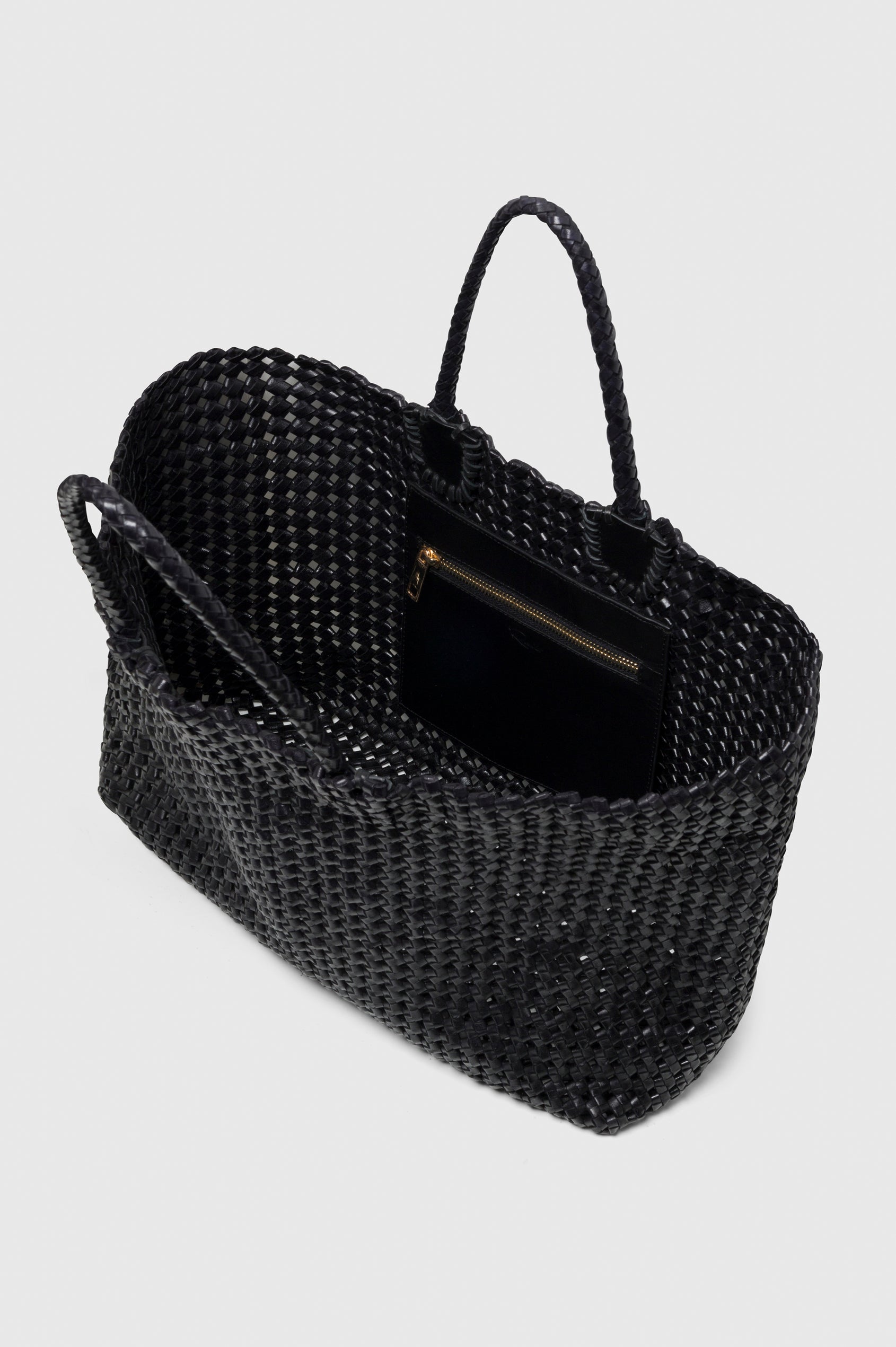 Brava Tote in Woven Leather With Top Handles and Spacious Interior in Black Colorway - angeled view, off model, opened.