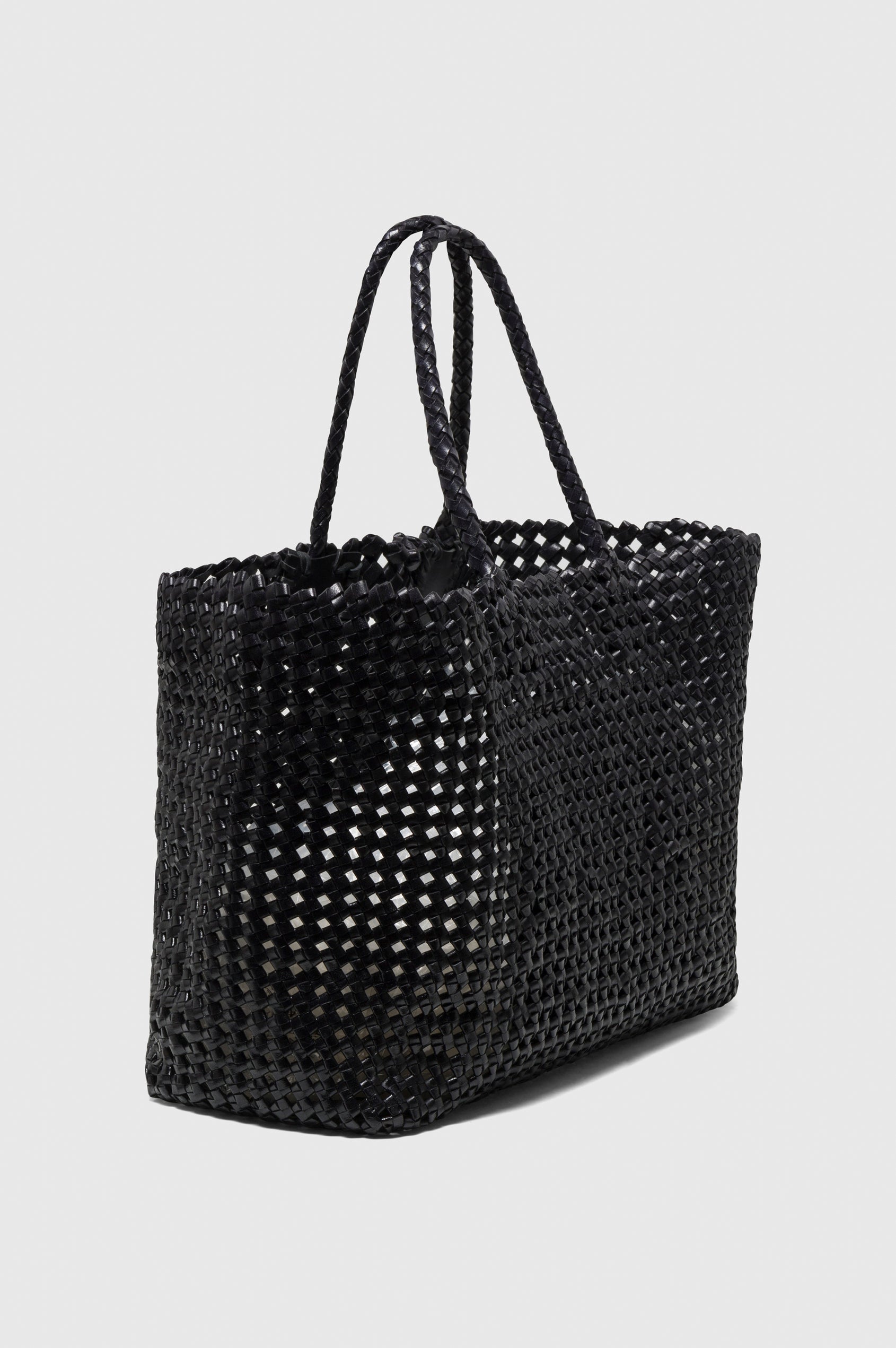 Brava Tote in Woven Leather With Top Handles and Spacious Interior in Black Colorway - side view, off model.