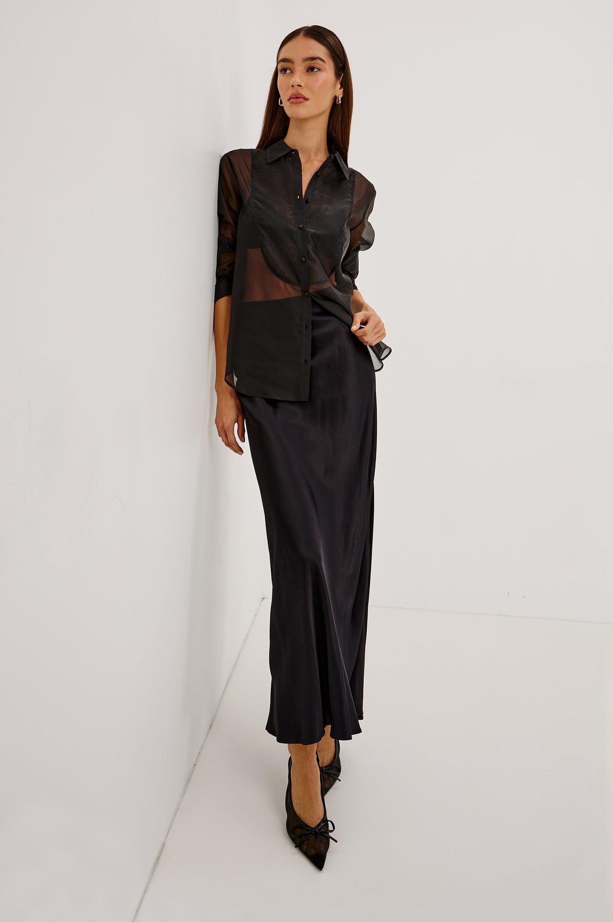 The Bretton Shirt in Sheer Organza With Oversized Fit, Spread Collar, Front Button Placket, and Long Sleeves in Black Organza Colorway - Upper Body Front View Featured on Model.