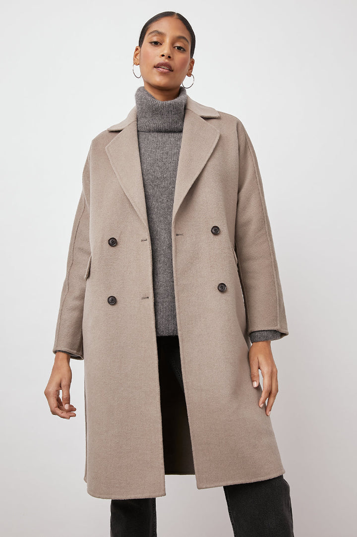 Bristol Knee-Length Double Breasted Coat with Two-Button Closure, Notched Lapels, Two Front Flap Pockets, Center Back Seams, and a Belted Back in Mink Colorway, a Light Brown - Front View Featured on Model  
