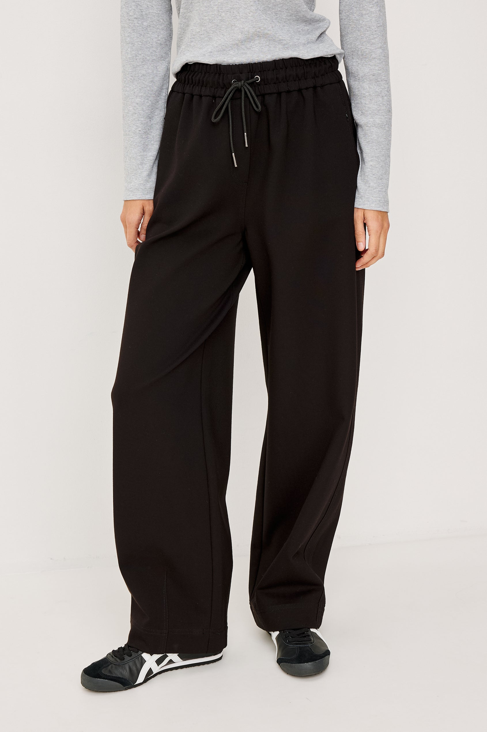 Bronwin Pant in Ponte With Elastic Waistband With Adjustable Ties, Side Zip Pockets, and Barrel Hem in Black Colorway - Lower Body Front View Featured on Model