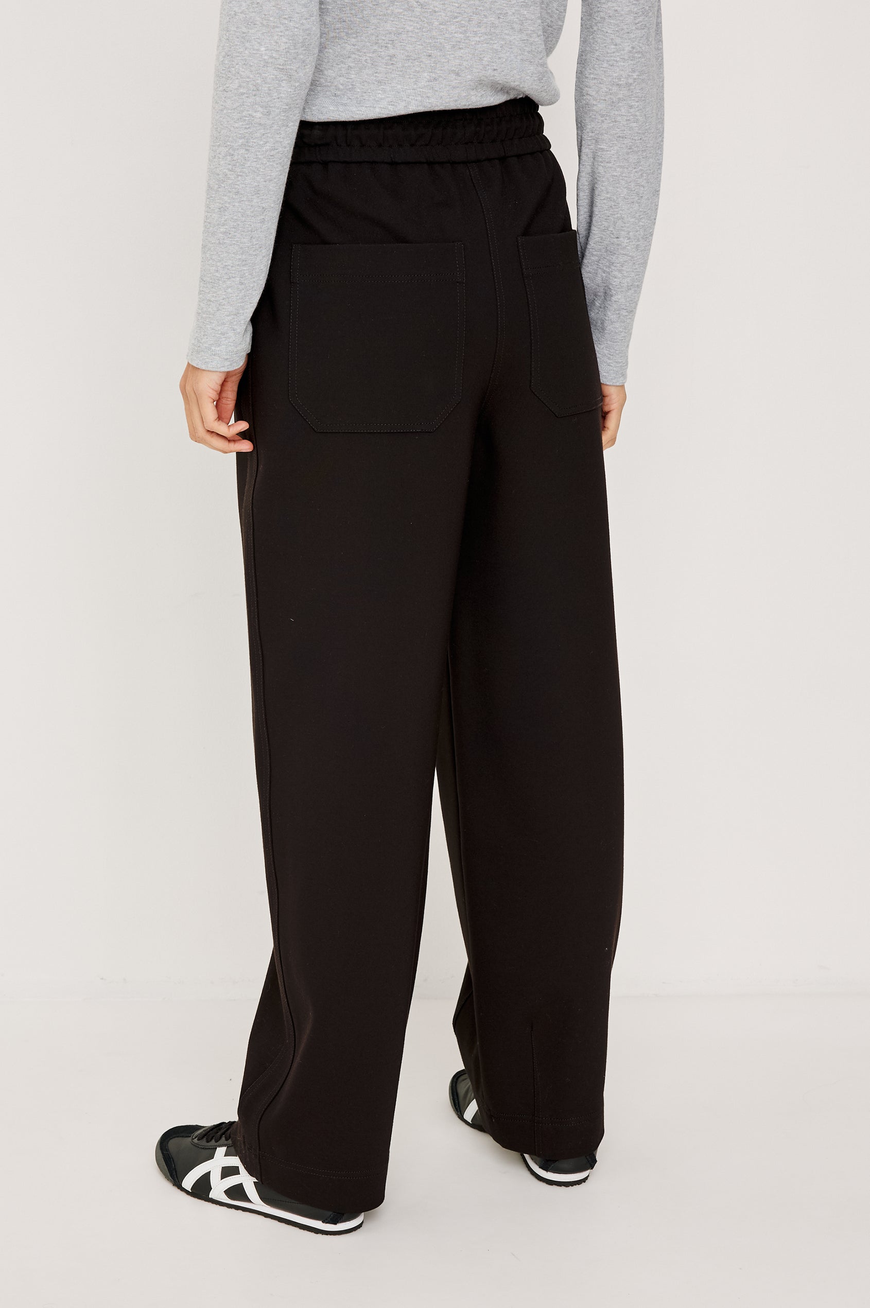 Bronwin Pant in Ponte With Elastic Waistband With Adjustable Ties, Side Zip Pockets, and Barrel Hem in Black Colorway - Lower Body Back View Featured on Model