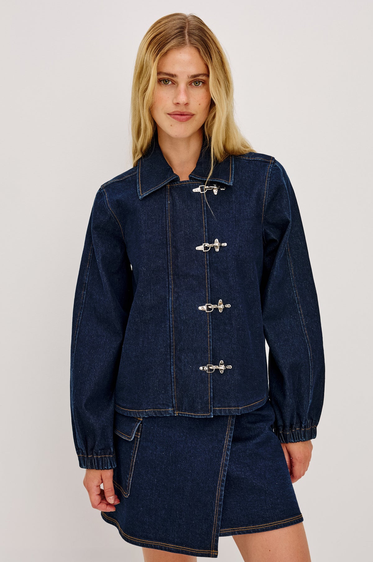Brooke Jacket in Midweight Denim With Duffel Slightly Cropped Fit, Long Balloon Sleeves, Elastic Cuffs, Back Yoke Pleat, and Front Toggle Closures in Rinse Indigo Colorway - Upper Body Front View Featured on Model