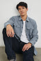 Burr Collared Shirt Jacket with Button Closure, Two Chest Button Flap Pockets and Textured Fabric in Denim White Colorway - Front Unbuttoned Full Body View Featured on Seated Model