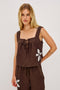 Calais Tank Top in Heavy Linen With Boxy, Loose Relaxed Cropped Fit, Wide Shoulder Straps, and V-Neckline With Adjustable Front Ties in Cocoa Floral Embroidery Colorway - Full Body Front View Featured on Model