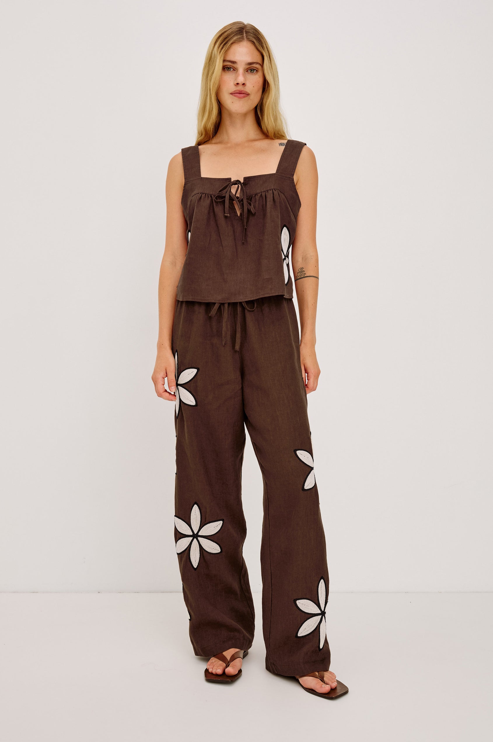 Calais Tank Top in Heavy Linen With Boxy, Loose Relaxed Cropped Fit, Wide Shoulder Straps, and V-Neckline With Adjustable Front Ties in Cocoa Floral Embroidery Colorway - Upper Body Front View Featured on Model