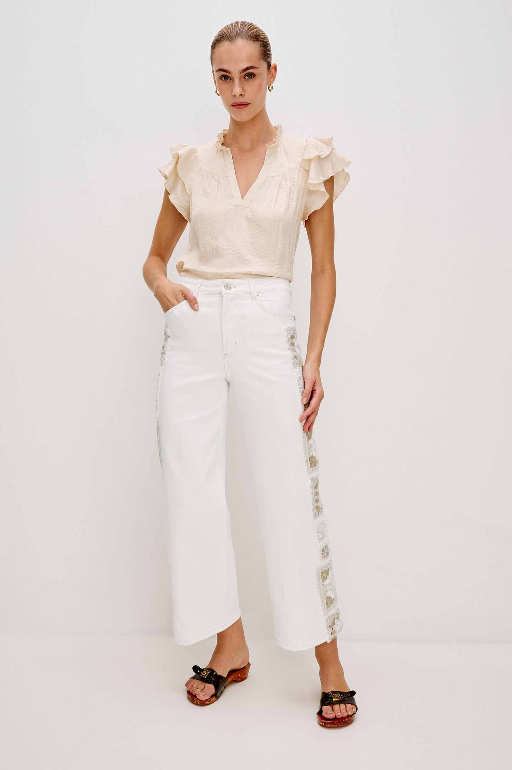 Calista V-Neck Ruffle Sleeve Blouse with a Ruffled Neckline and Gathered Front Yoke in Ivory Colorway. Full Body Front View Shown on Model.