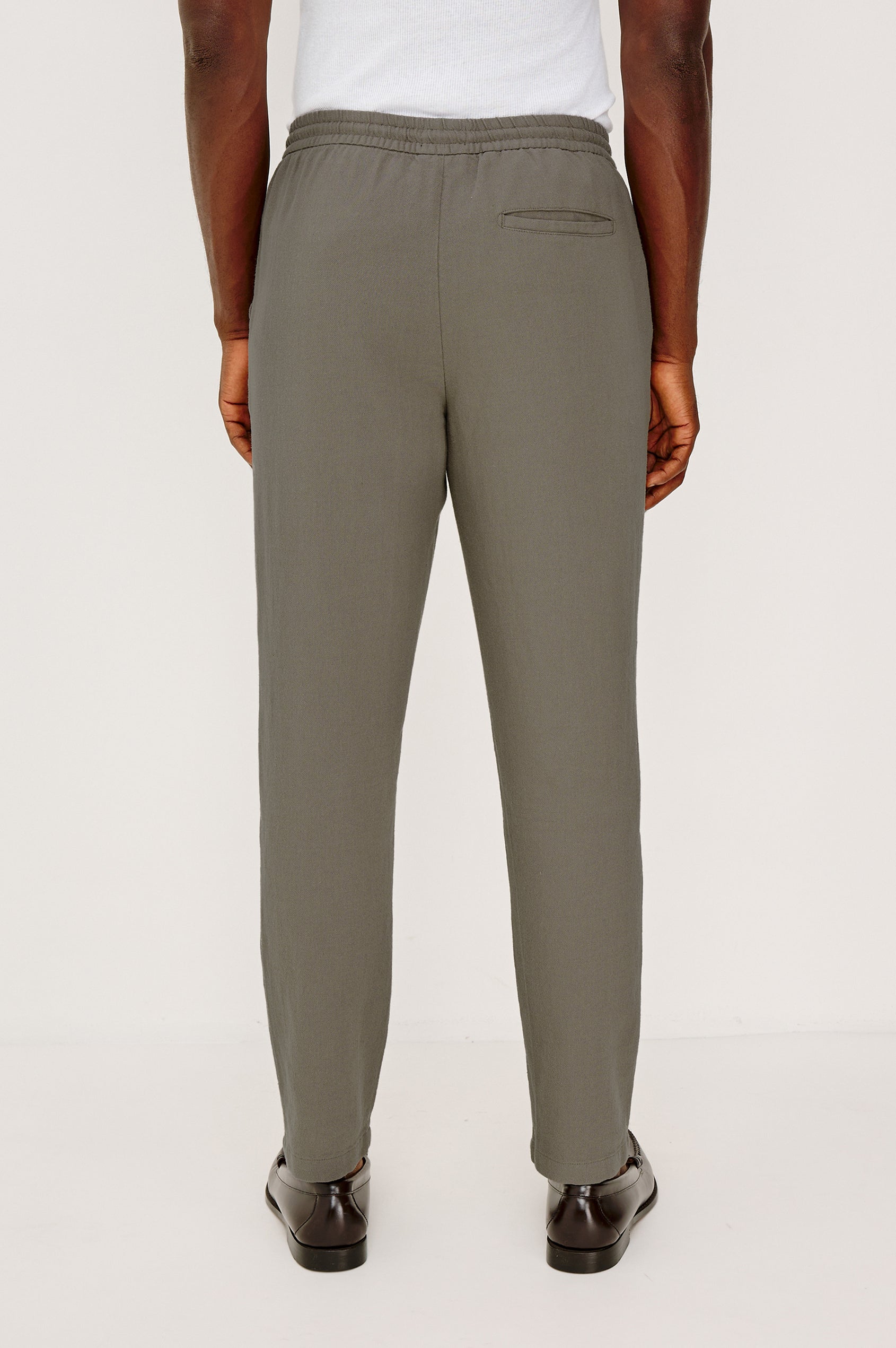 Callum Tapered Straight Leg Pant in Linen Twill With Adjustable Drawstring Waistband Ties in Fallen Rock Colorway - Lower Body Back View Featured on Model
