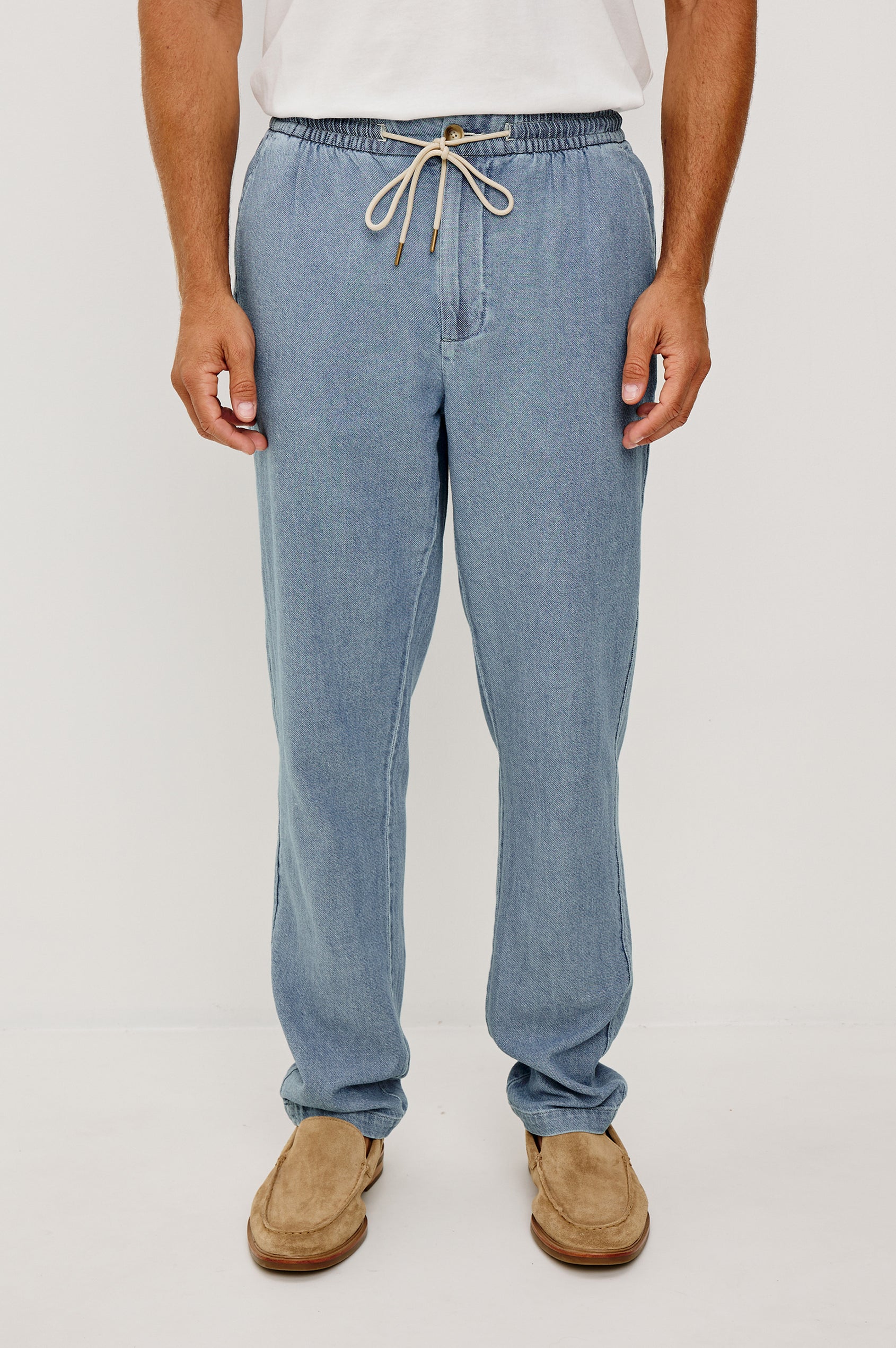 Callum Tapered Straight Leg Pant in Linen Twill With Adjustable Drawstring Waistband Ties in Medium Wash Indigo Colorway - Lower Body Front View Featured on Model