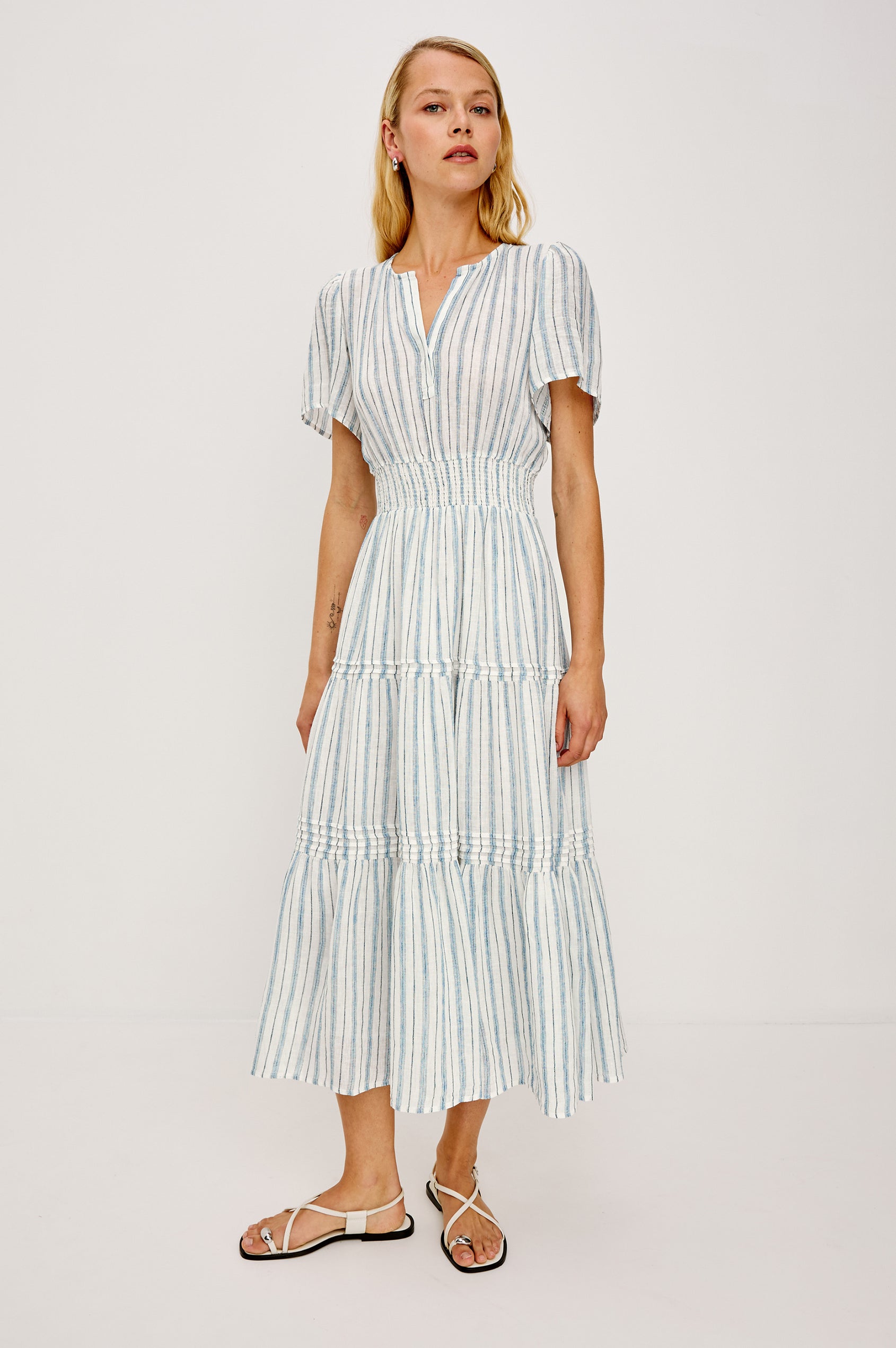 Cannes Midi in Linen With Half Placket Neckline Short Sleeves Smocked Waist and Tiered Skirt in Windward Stripe - Full Body Front View Featured on Model