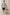 Carson linen short sleeve button down with a collar and blue botanical pattern in Autumn Daisy Ocean - full body front view on model, posing with chair