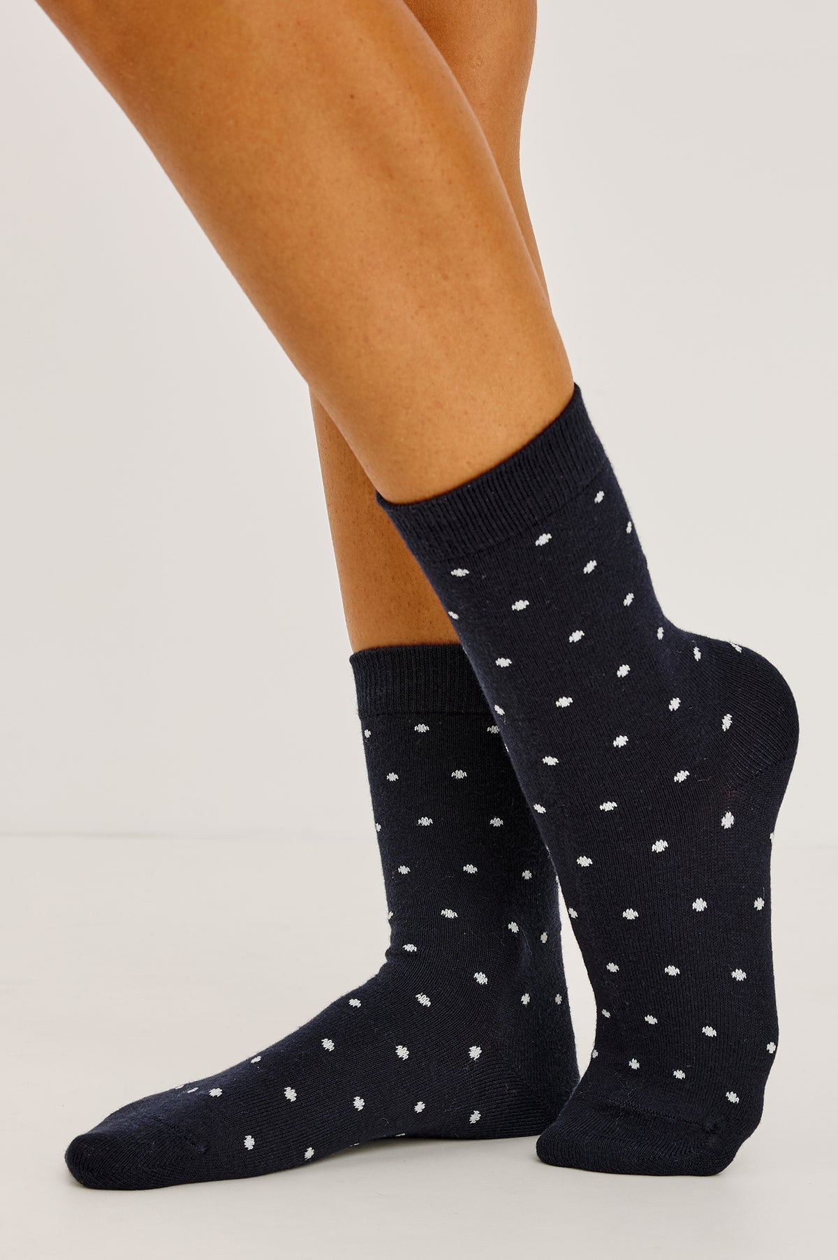 Cashmere Crew Socks in Soft Cotton-Cashmere Blend With Ribbed Cuffs in Navy Polka Dot Colorway - Upper Body Front View Featured on Model.