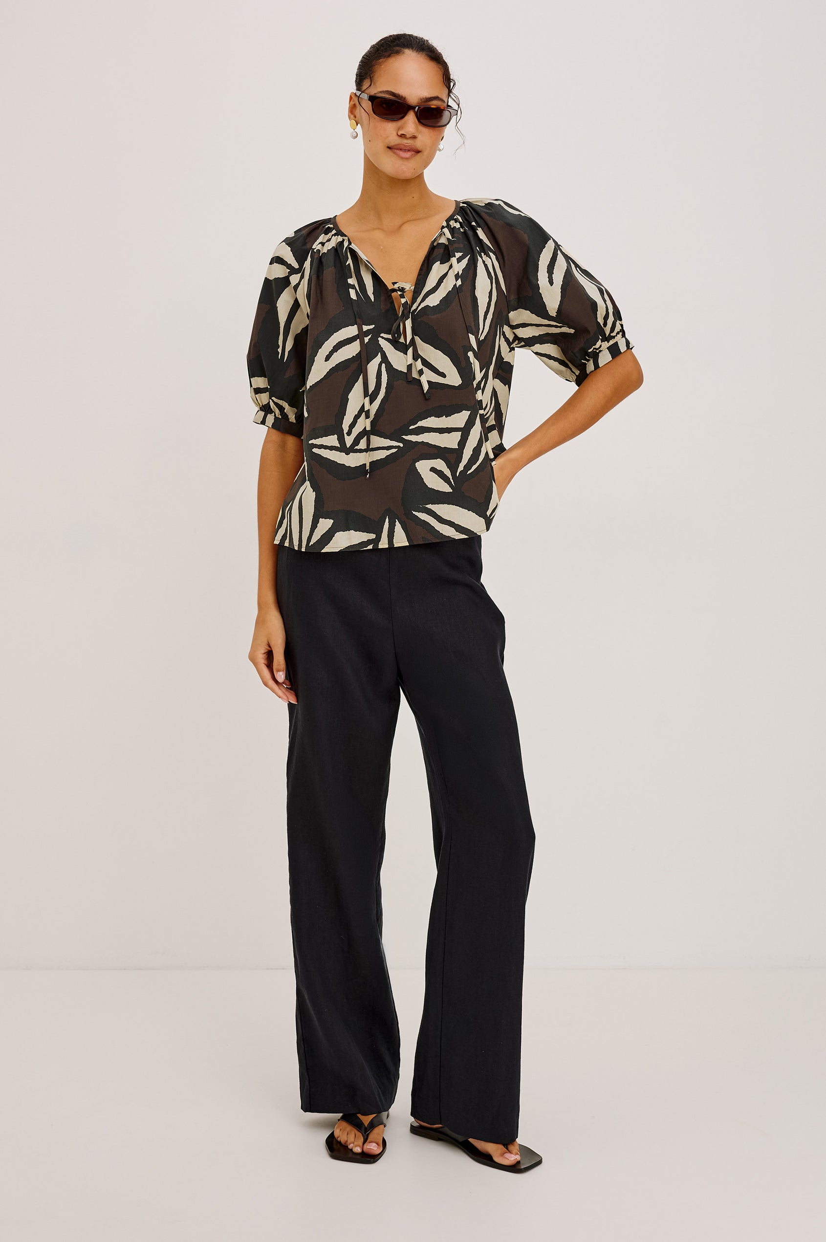 Catalene Peasant Blouse in Cotton Voile With Self-Tie V-Neckline, Loose Fit, and Short Puff Sleeves in Cocoa Floral Colorway - Full Body Front View Featured on Model