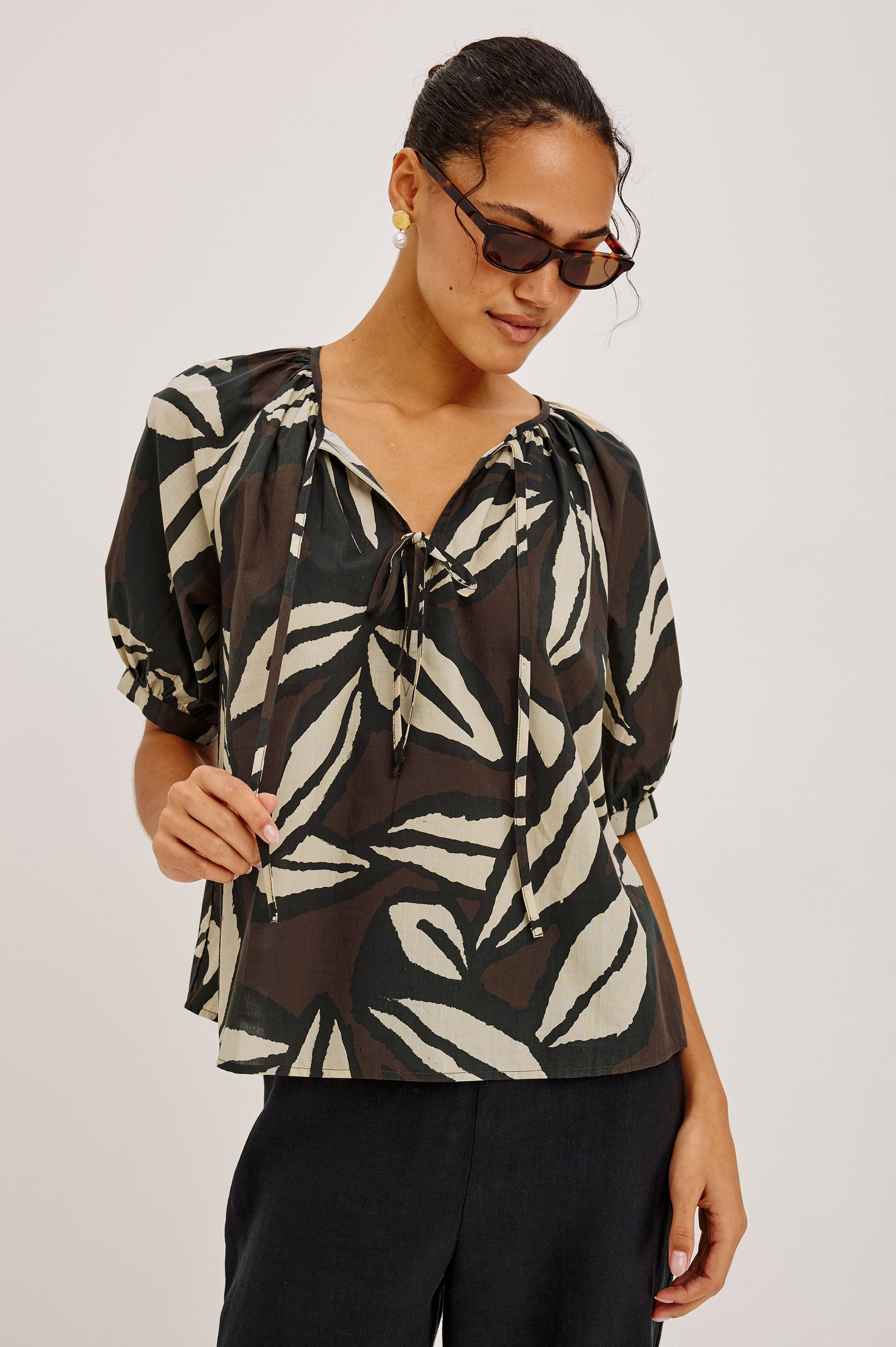 Catalene Peasant Blouse in Cotton Voile With Self-Tie V-Neckline, Loose Fit, and Short Puff Sleeves in Cocoa Floral Colorway - Upper Body Front View Featured on Model