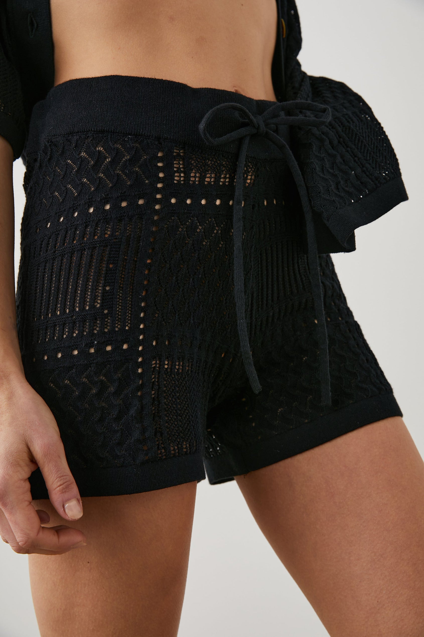 Cataline Shorts with a Drawstring Waist and an Open Stitch Grid with Geometric Designs in Black Colorway - Front View Featured on Model 
