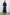Caterine Maxi Dress with Mid-length Sleeves, a V neck, a Shirred Collar with a tie, a Smocked Waist, and a Tiered Skirt in Navy Colorway - Back Full Body View Featured on Model