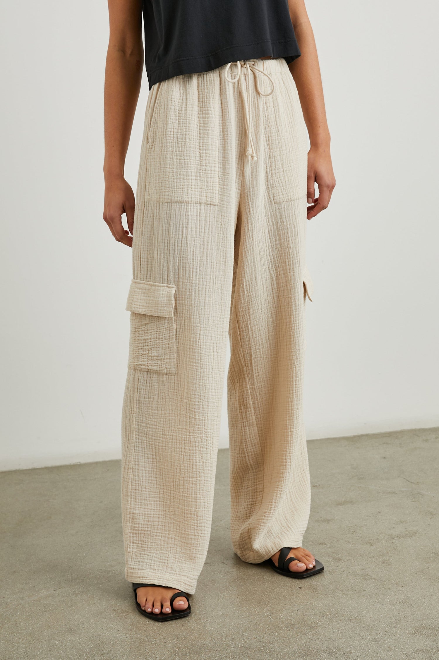 Christiano Pants with a Drawstring Waist, Two Front Pockets and Two Flap Side Pockets in Flax Colorway - Front View Featured on Model  