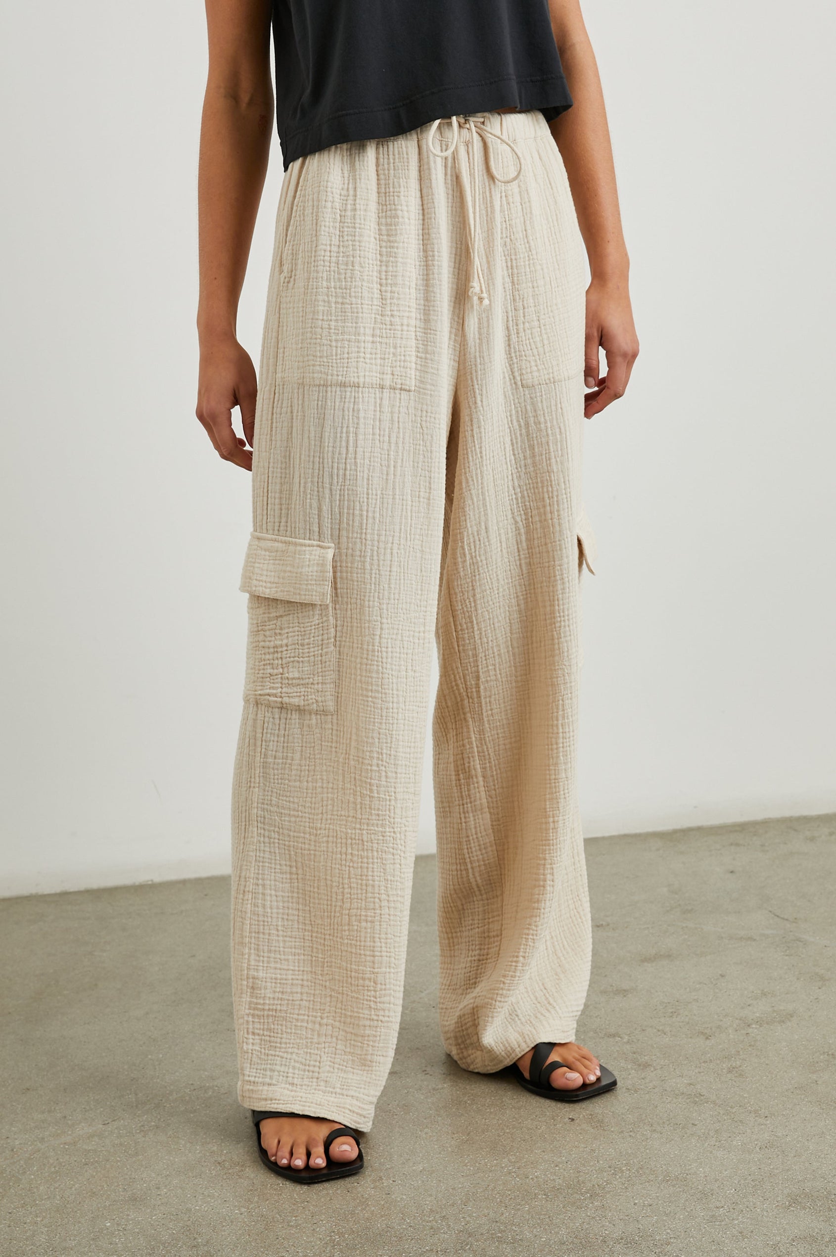Christiano Pants with a Drawstring Waist, Two Front Pockets and Two Flap Side Pockets in Flax Colorway - Front View Featured on Model  