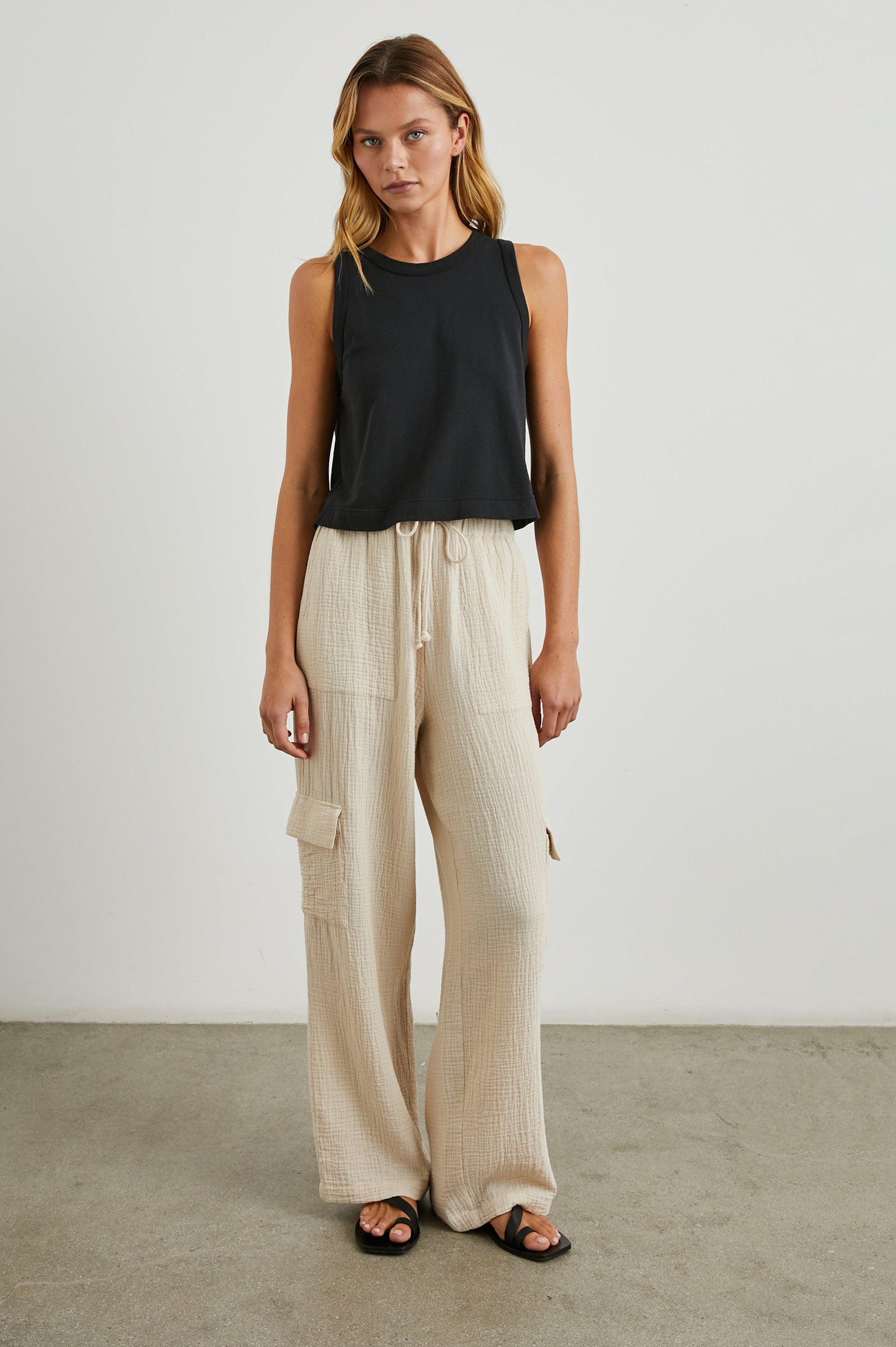 Christiano Pants with a Drawstring Waist, Two Front Pockets and Two Flap Side Pockets in Flax Colorway - Front Full Body View Featured on Model  