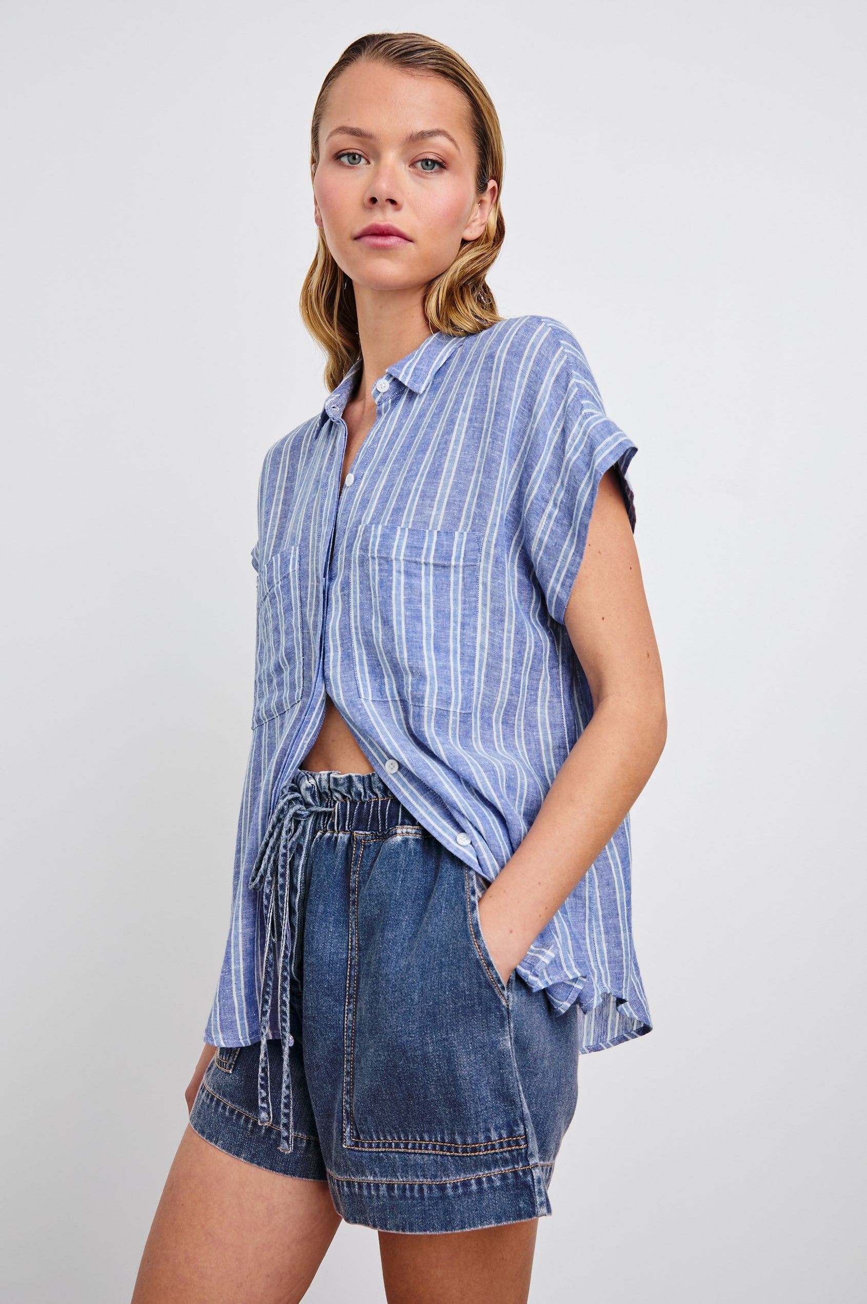 Cito Short-Sleeve Button Down with two Chest Patch Pockets in Lake View Stripe Colorway, Vertical Stripes in Blues and White - Side Untucked View Featured on Model