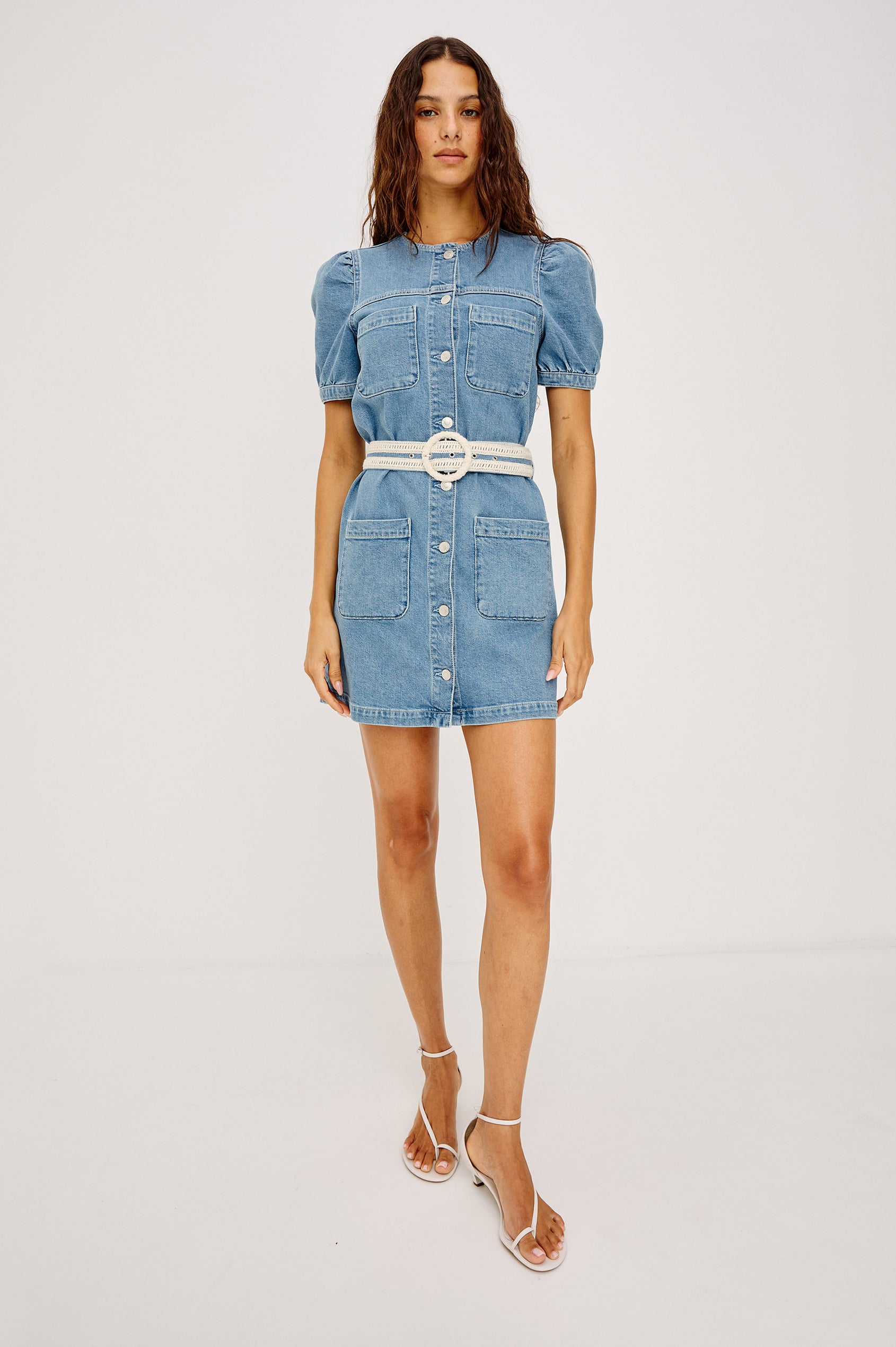Clairemont Mini Shift Dress in Light Stretch Denim With Front Button Closures, Short Puff Sleeves, Front Patch Pockets, and an Adjustable Braided Belt in Sorrento Braided Colorway - Full Body Front View Featured on Model