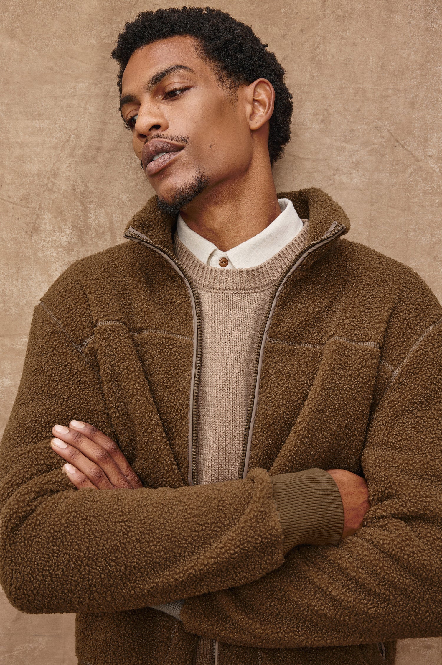 The Clark is a zip front brushed back polar fleece and details include contrast stitching, two zipper pockets, and contrast  grey ribbed cuffs in Lichen colorway. Front view featured on model.