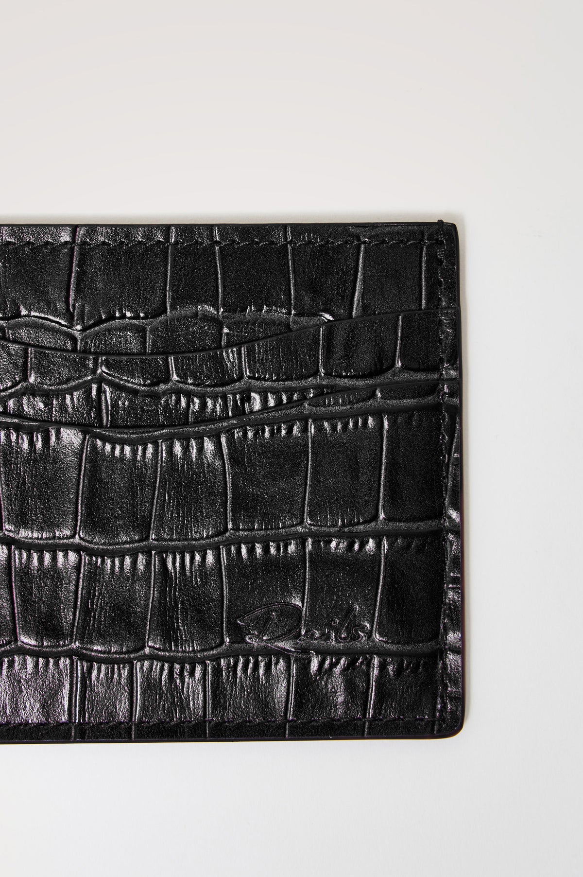 Classic Card Holder in Croc-Embossed Spanish Leather With Top Pocket, Two Front Slip Pockets, and Embossed Rails Logo in Black Croc Embossed Colorway - front close-up view