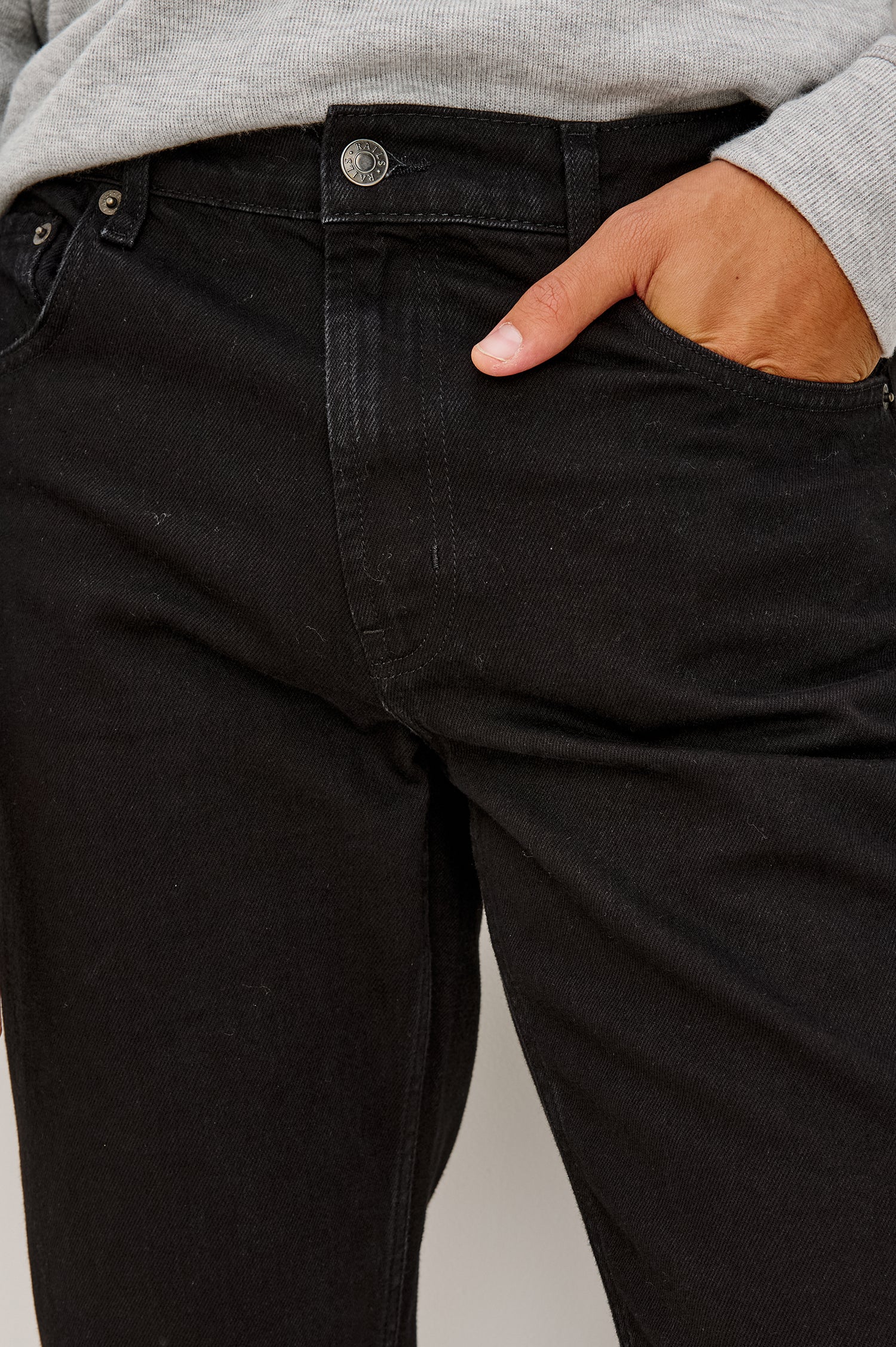 Clayton Slim Straight Jean With 5-Pocket Styling, Belt Loops, and Front Zip-Fly in Dark Black Colorway - Lower Body Front View Featured on Model