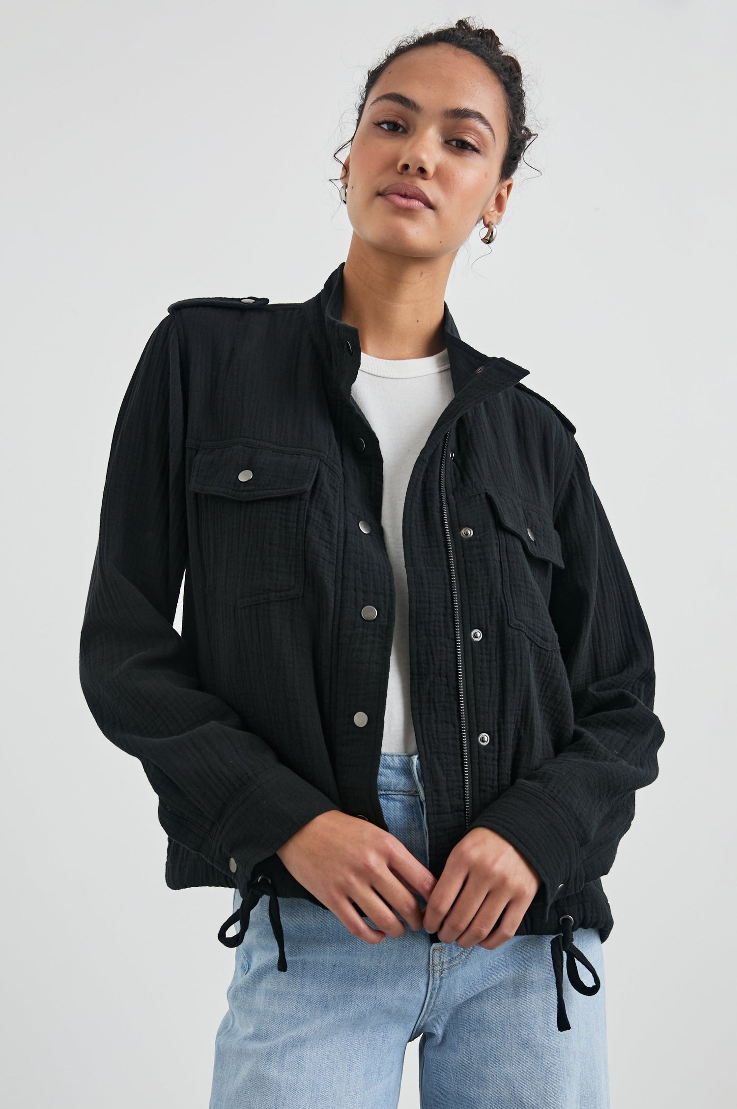 Collins Jacket with Zip and Snap Closure, Two Chest Snap Flap Pockets, Toggle Drawstring Hem, Snap Shoulder Straps and a Breathable Back Flap in Gauze Black Colorway - Front View Featured on Model