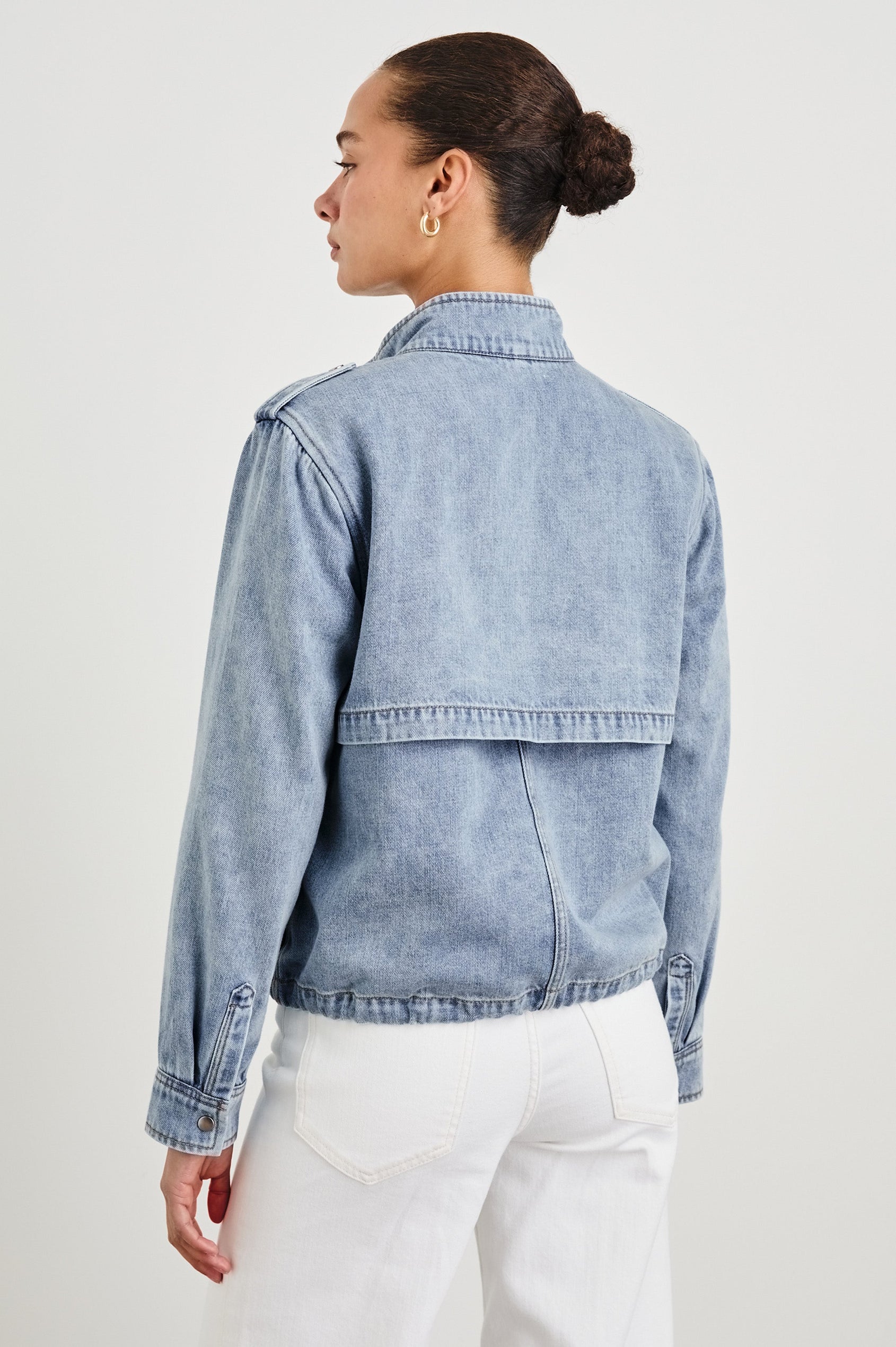 Collins military style jacket with cargo chest pockets and drawstring hem in Faded Indigo - back view on model