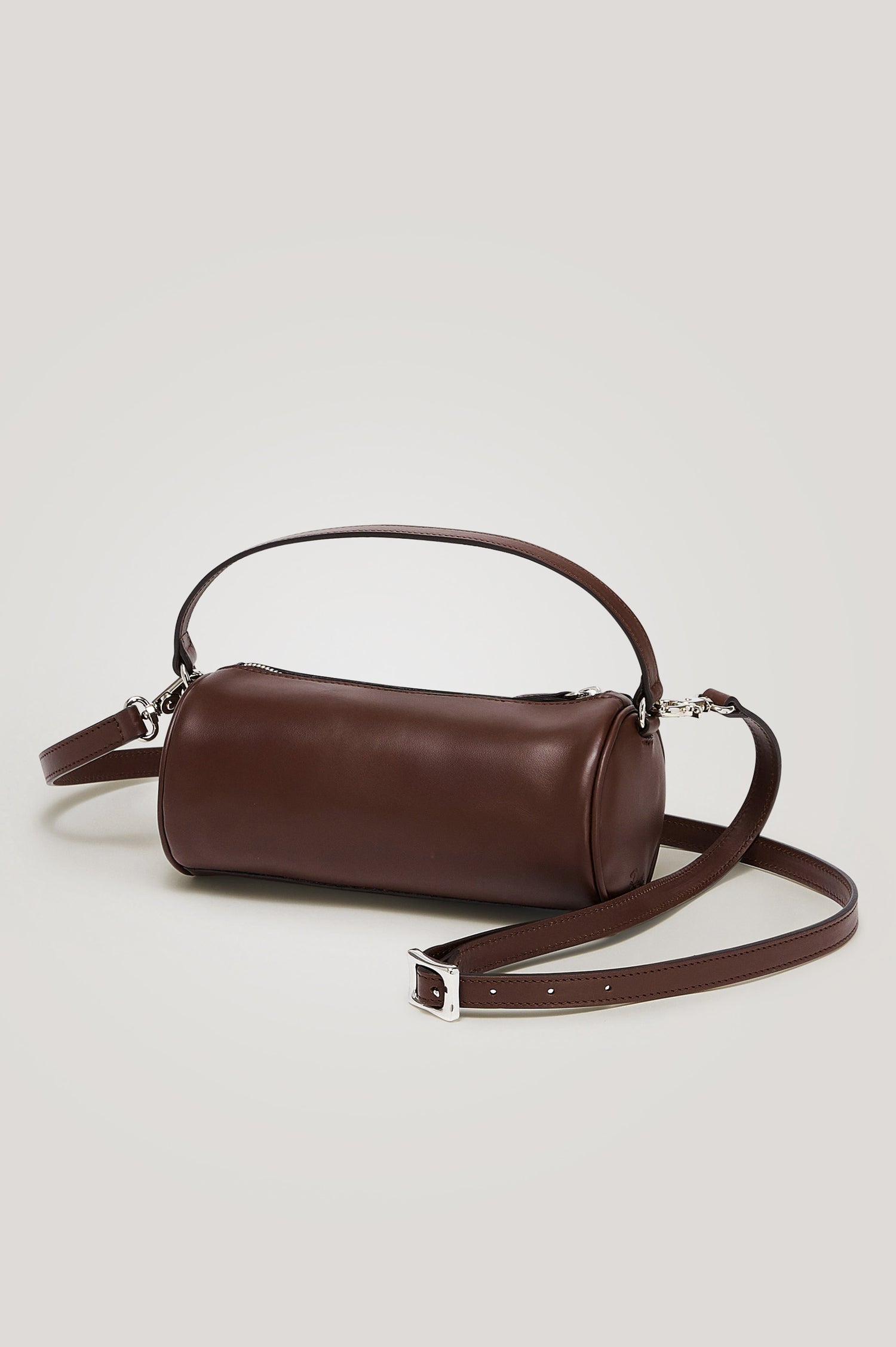 Como Mini Barrel Bag in Italian Leather With Fixed Top Strap, Removable and Adjustable Buckled Crossbody Strap, Top Zipper, Side-Embossed Logo, Branded Interior Label in Espresso Colorway - Side View Featured
