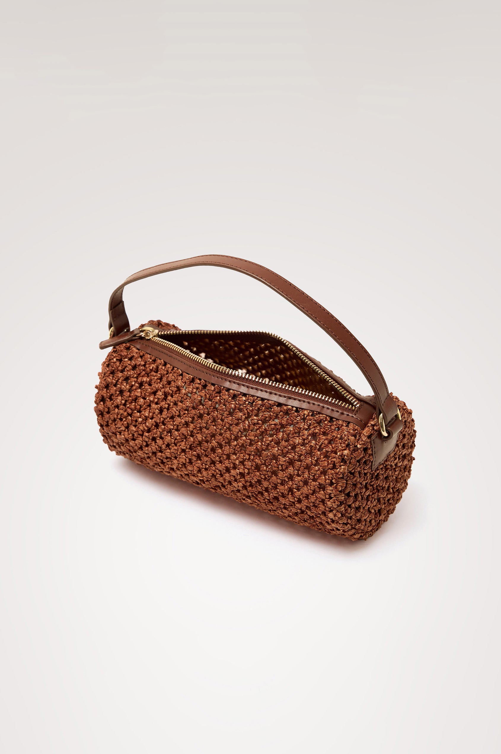 Como Mini Barrel Bag in Woven Raffia With Top Strap, Removable and Adjustable Crossbody Strap, and Top Zip in Cognac Raffia Colorway - Top View Featured