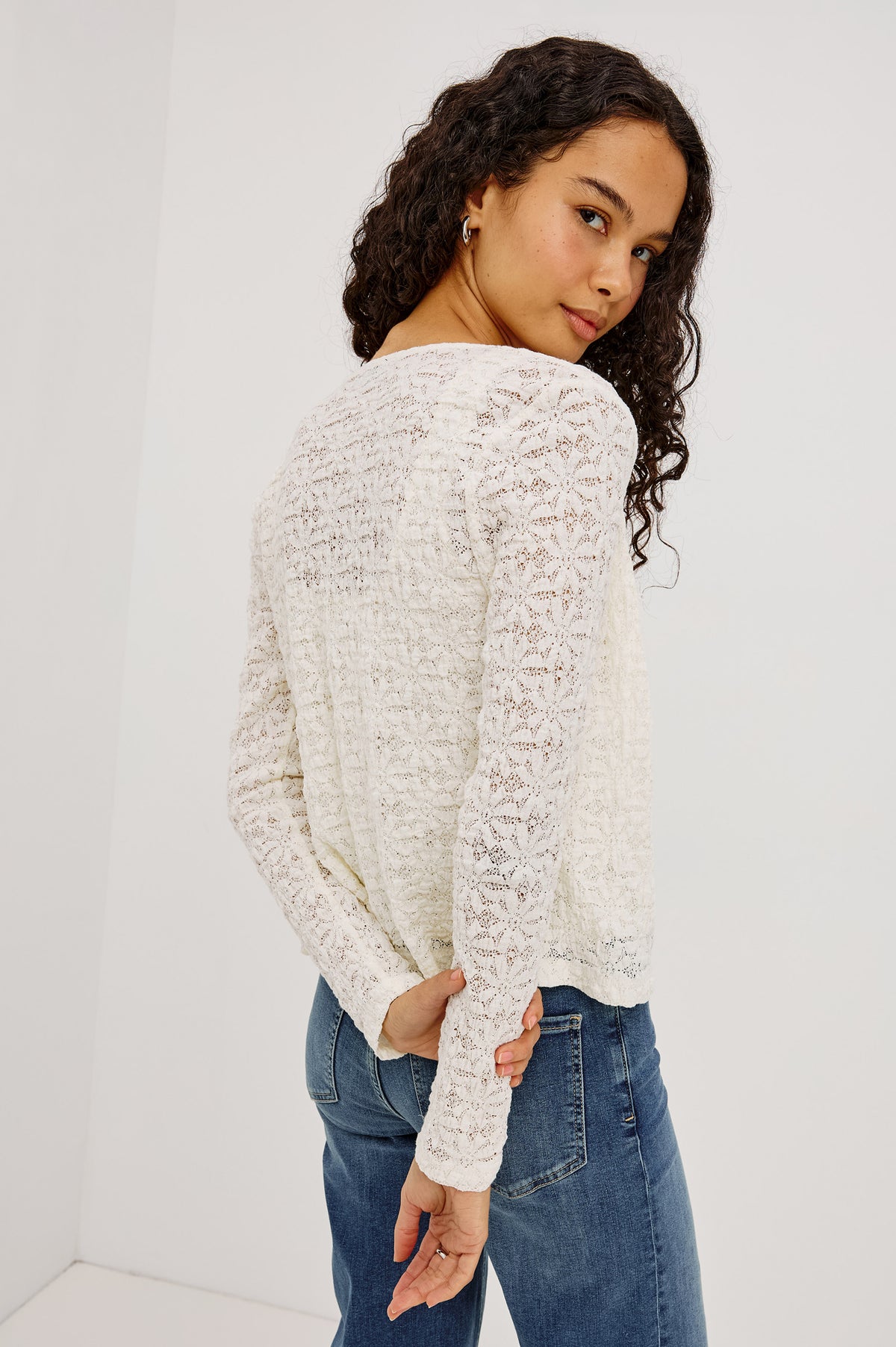 Cyrah Top in Sheer Stretch Lace With Long Sleeves, Front Button-and-Loop Closures, Crew Neckline, and Fitted Silhouette in Ivory Colorway - Upper Body Back View Featured on Model